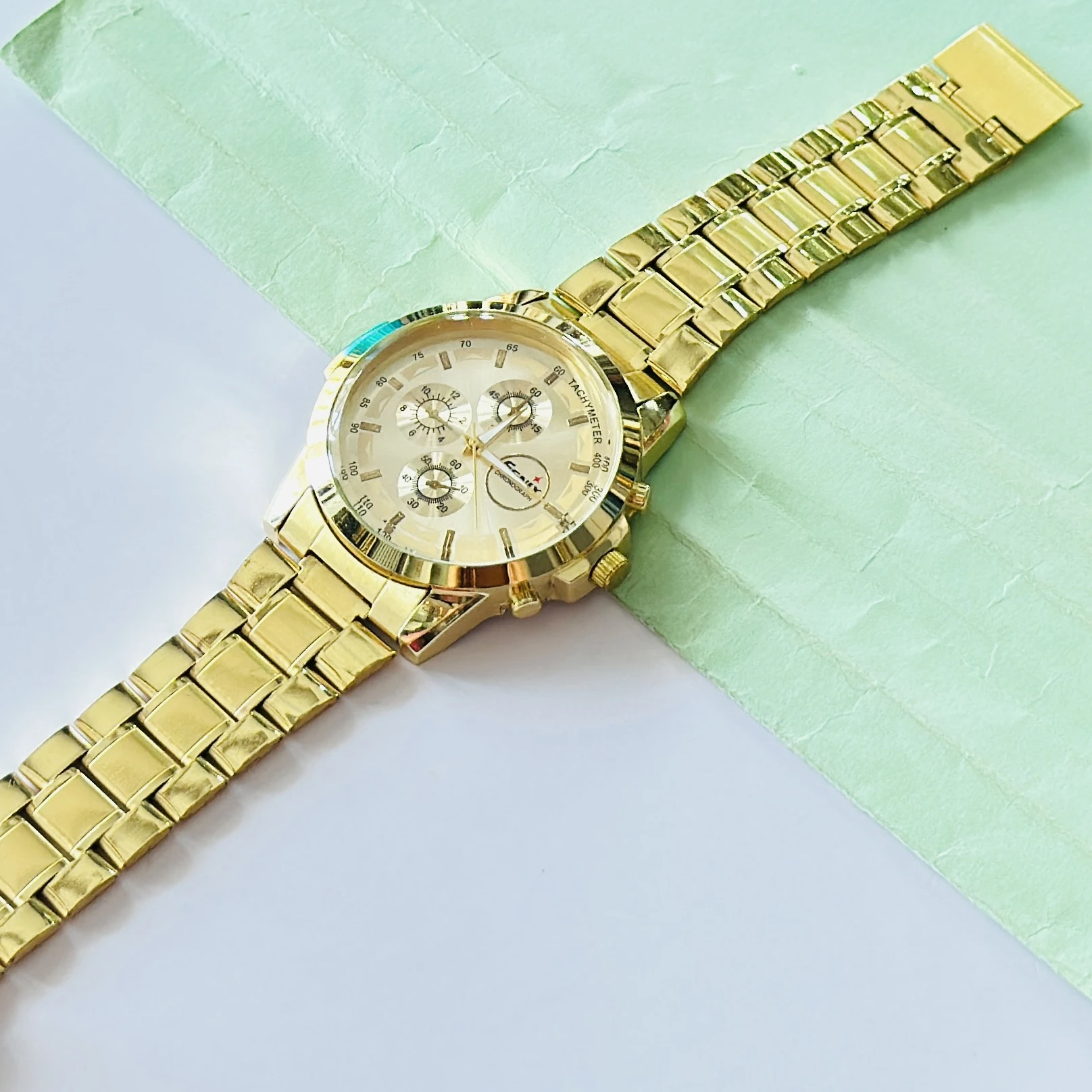 Gold coloured analogue watch
