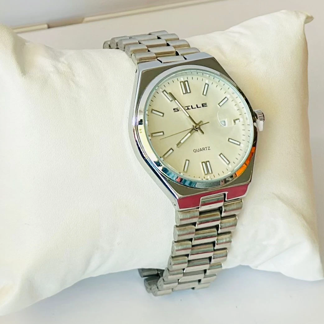 Snille analog quartz watch with a white dial and silver stainless steel strap.