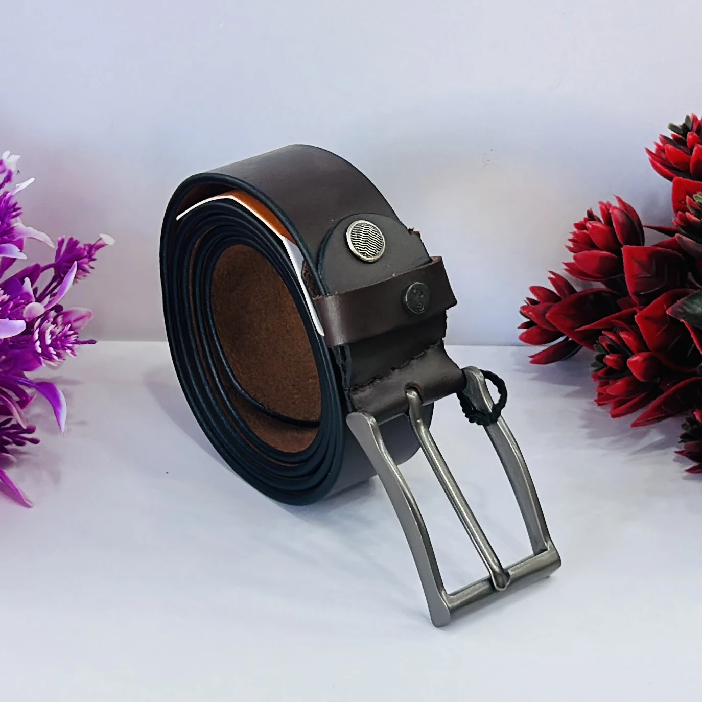 Brown leather belt with a metal buckle