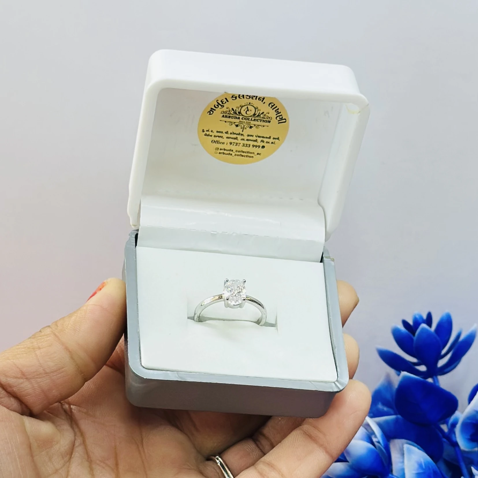 silver solitaire ring with a moissanite stone.