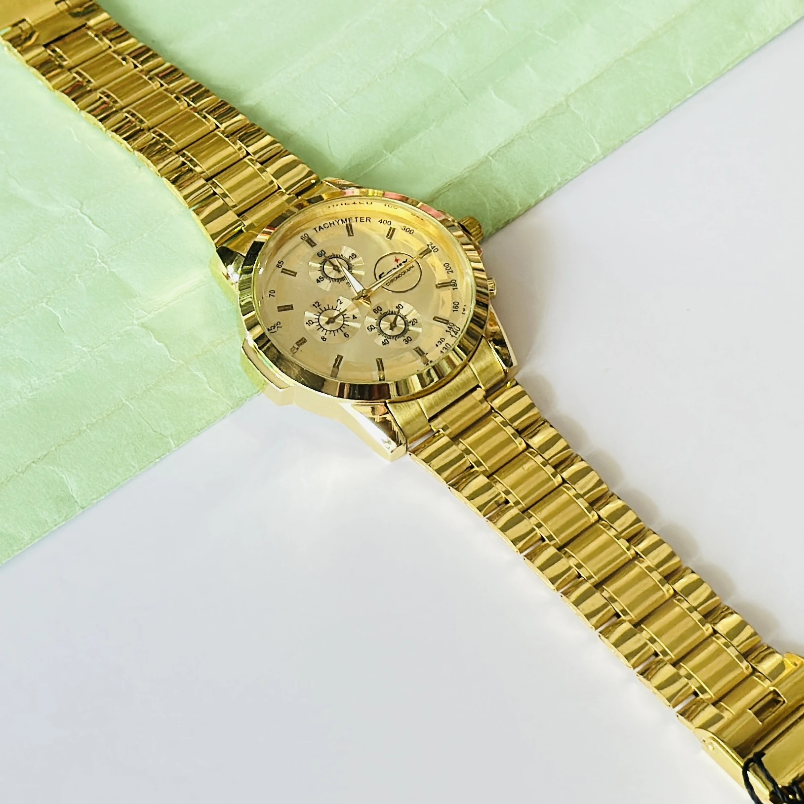 Gold coloured analogue watch