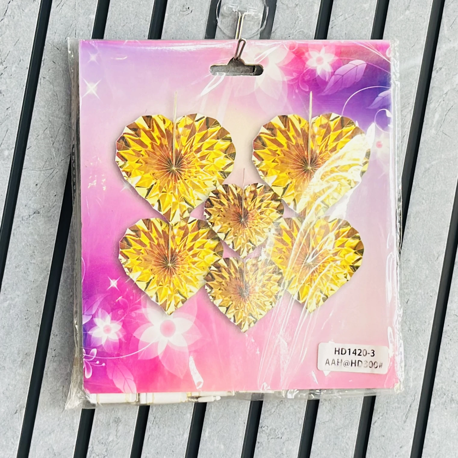 package of golden heart-shaped decorative paper fans