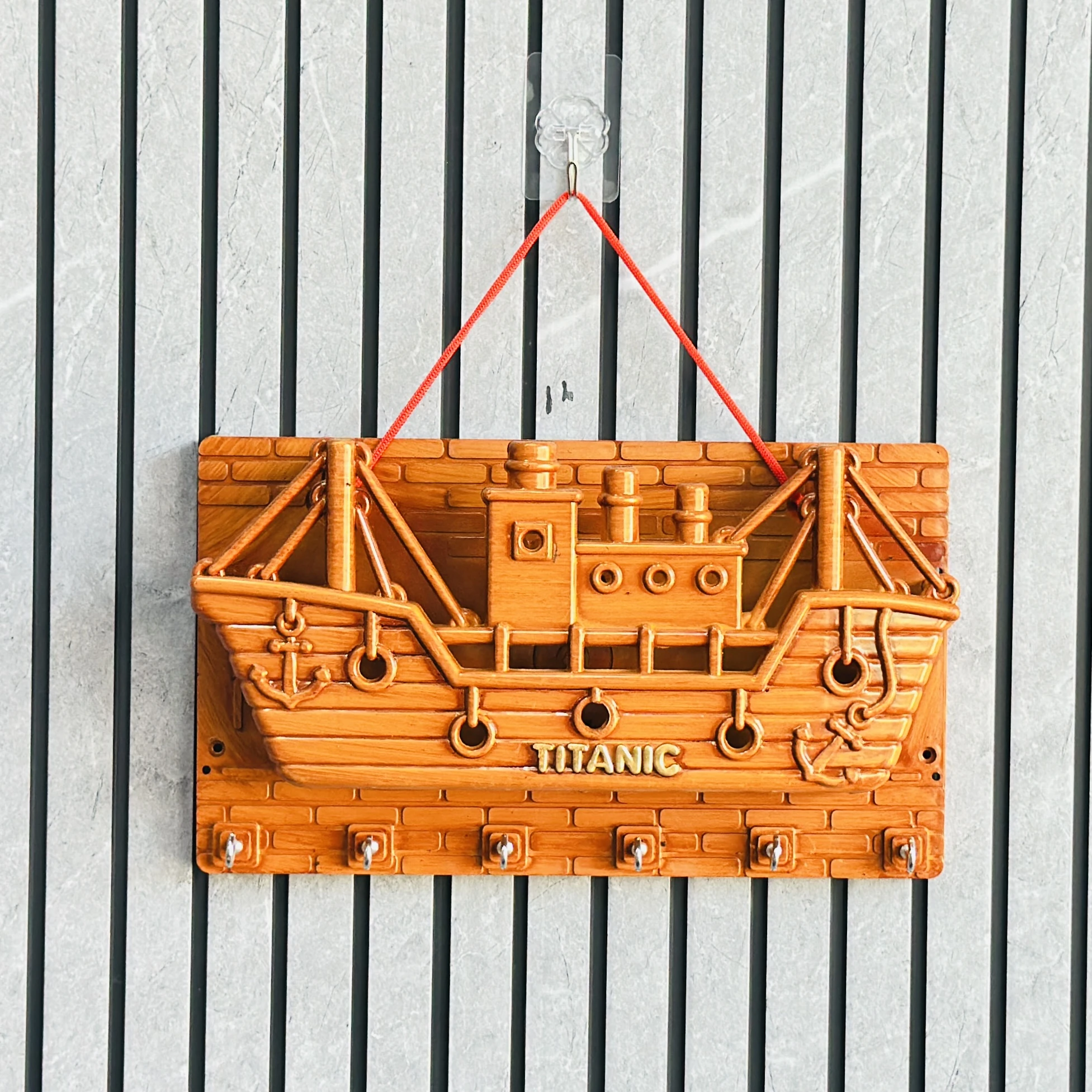 wooden wall-mounted key holder (BRYTZG )shaped like a ship labeled "TITANIC".