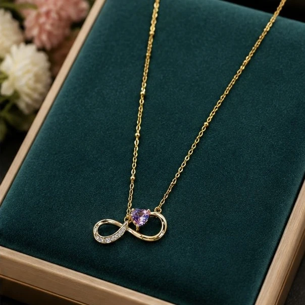 necklace from MonCheri features an infinity symbol pendant paired with a small pink heart