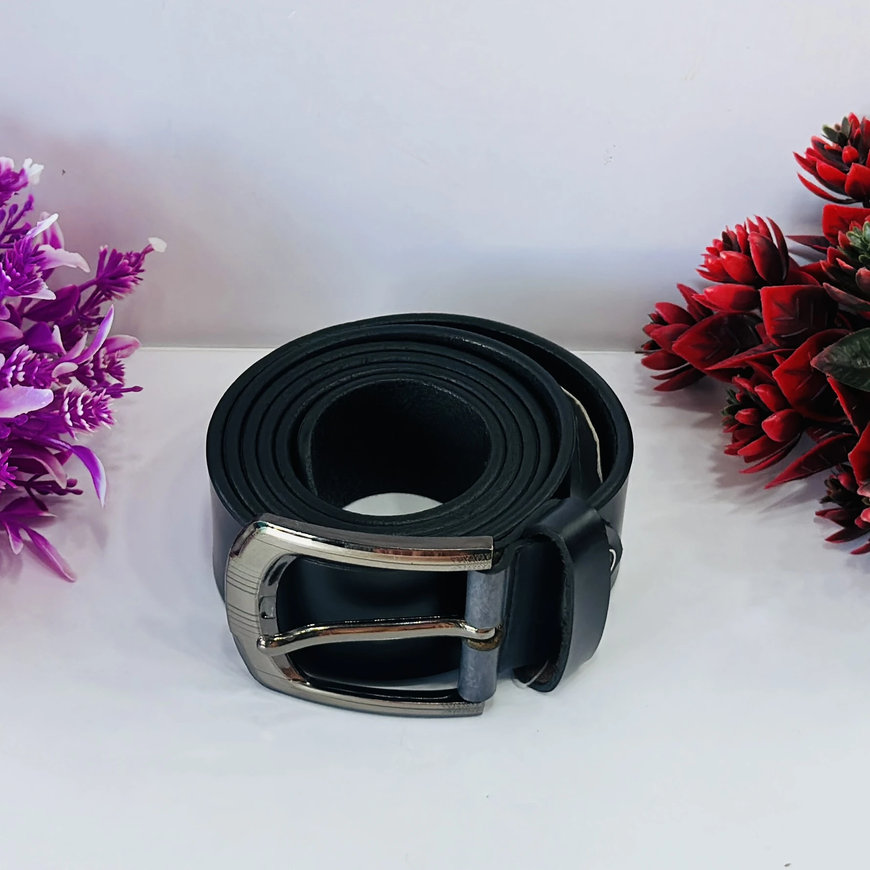 Black leather belt with a metal buckle.