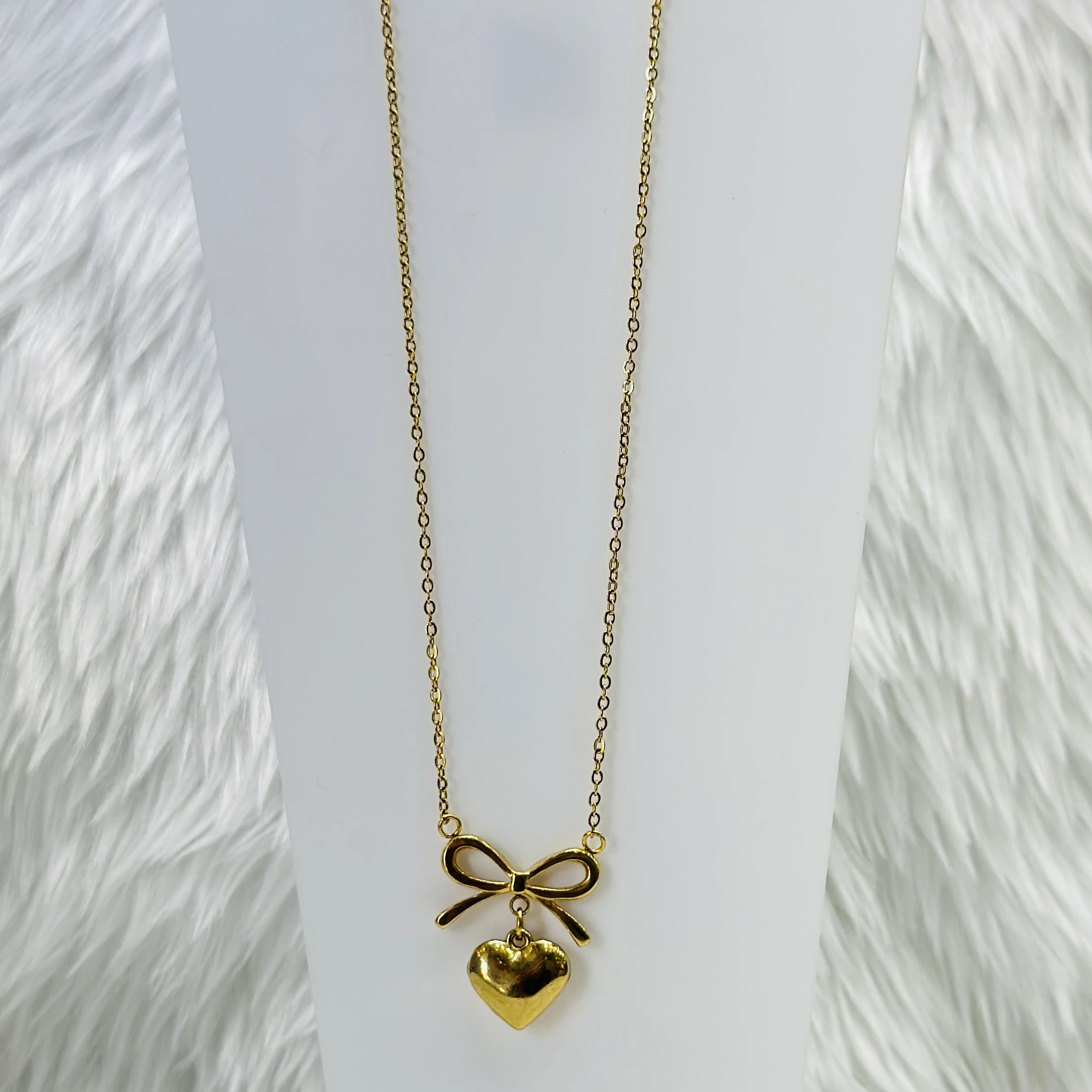 Gold plated stainless steel anti-tarnish necklace with a bow and heart pendant