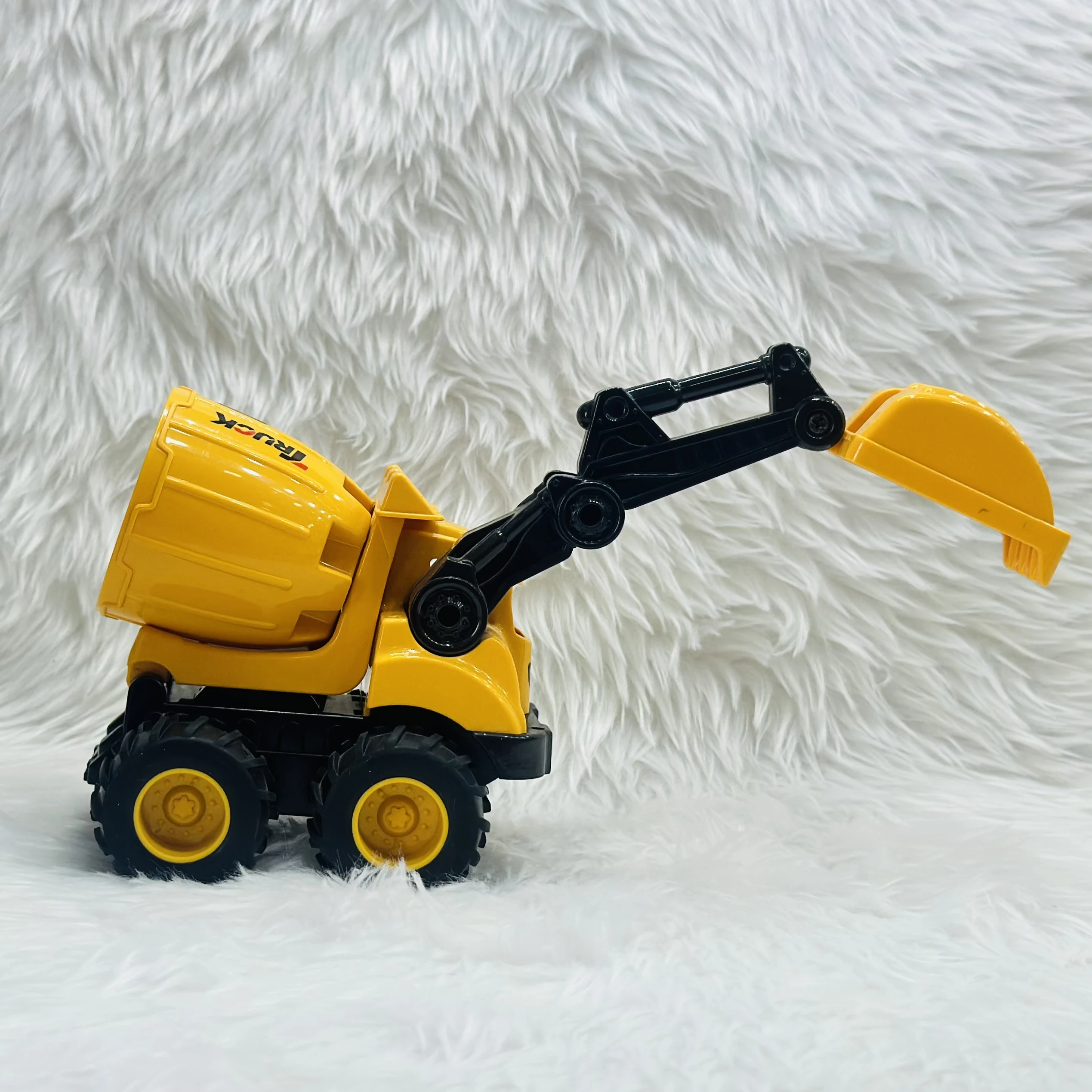 Cement mixer with an attached excavator arm.