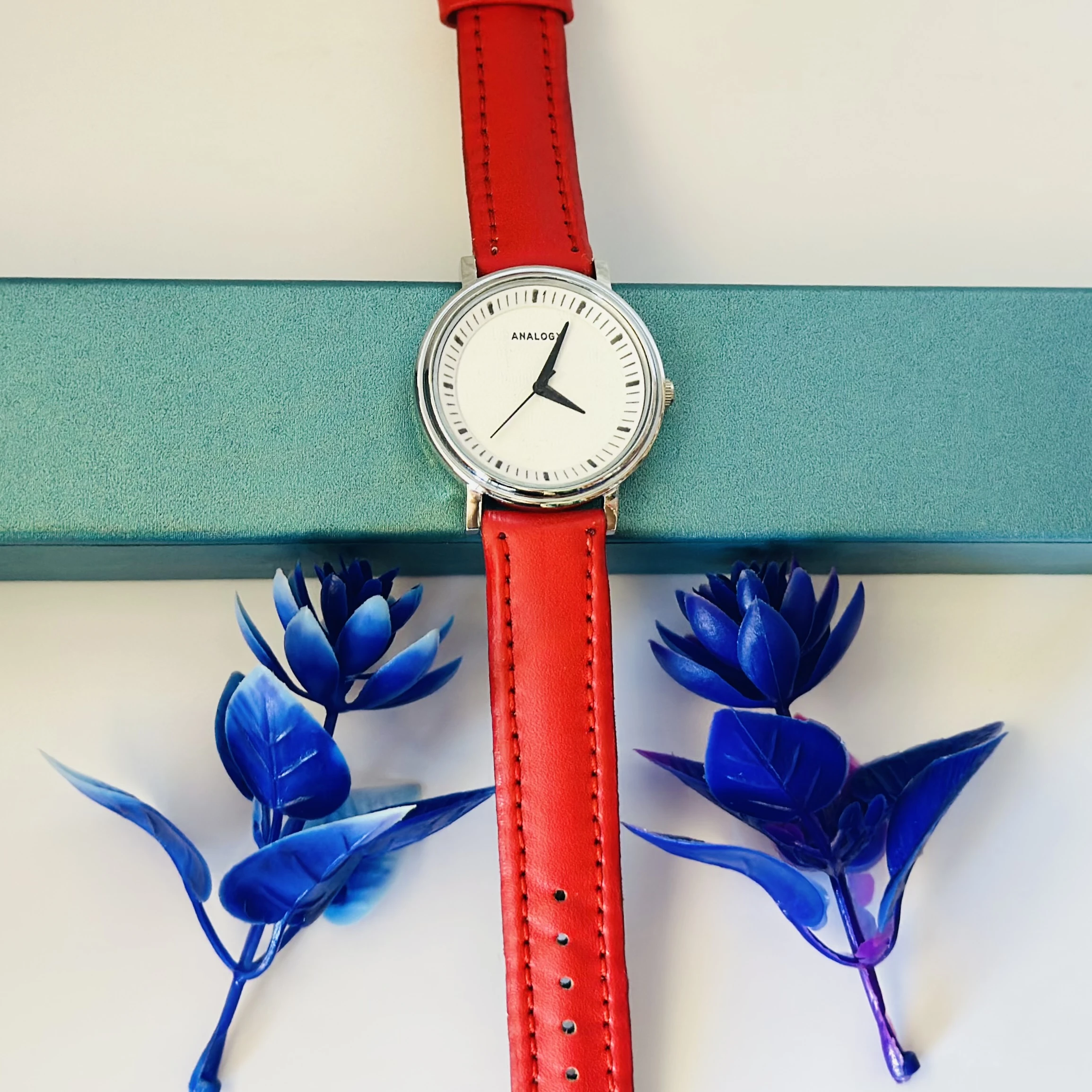 Red  analog watch with a red strap.