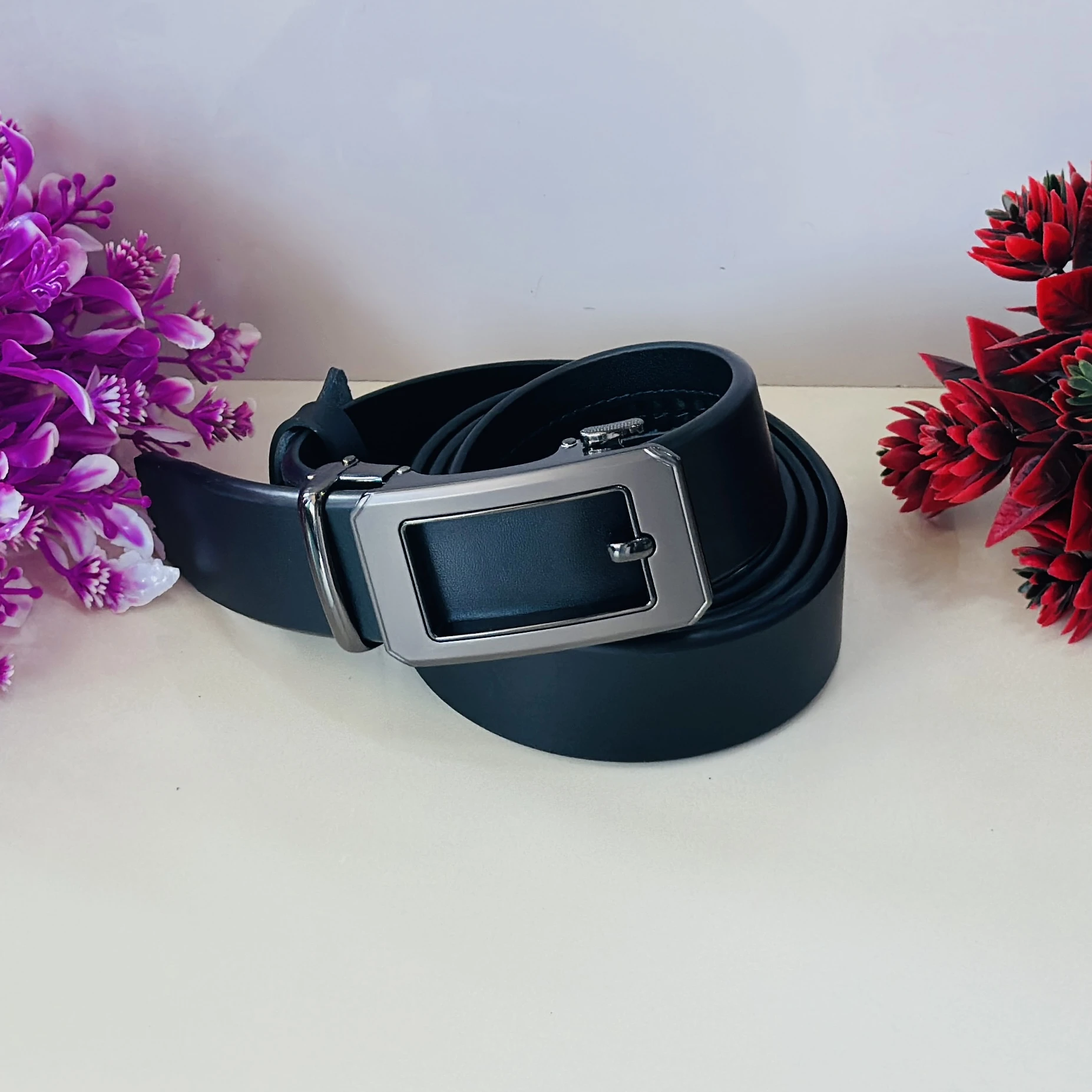 Black leather auto-lock or ratchet buckle belt for men.