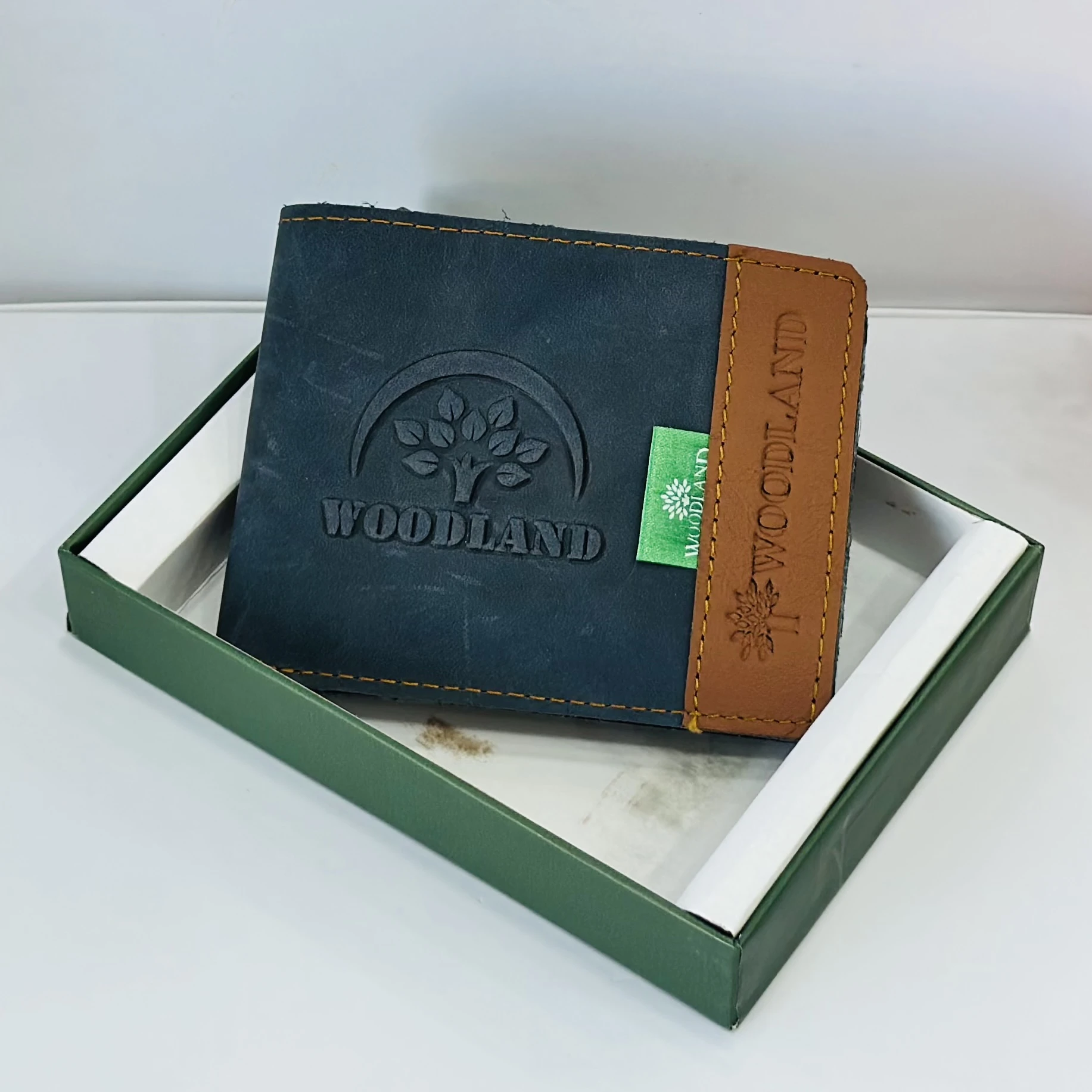 Woodland men's leather bi-fold wallet in a black and beige color block design.
