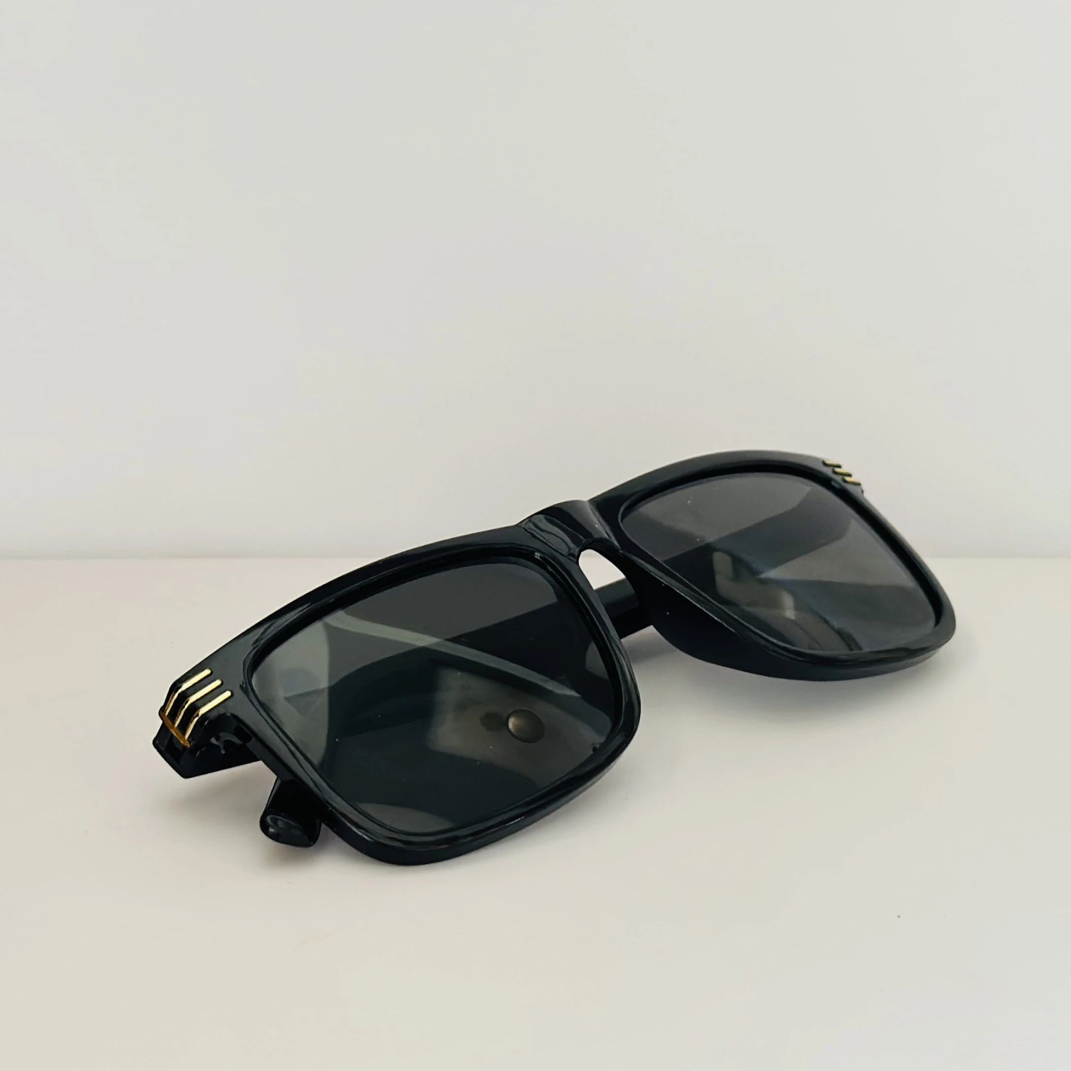Saint Laurent SL 710 OPT eyeglasses with a black acetate frame and gold-toned details.