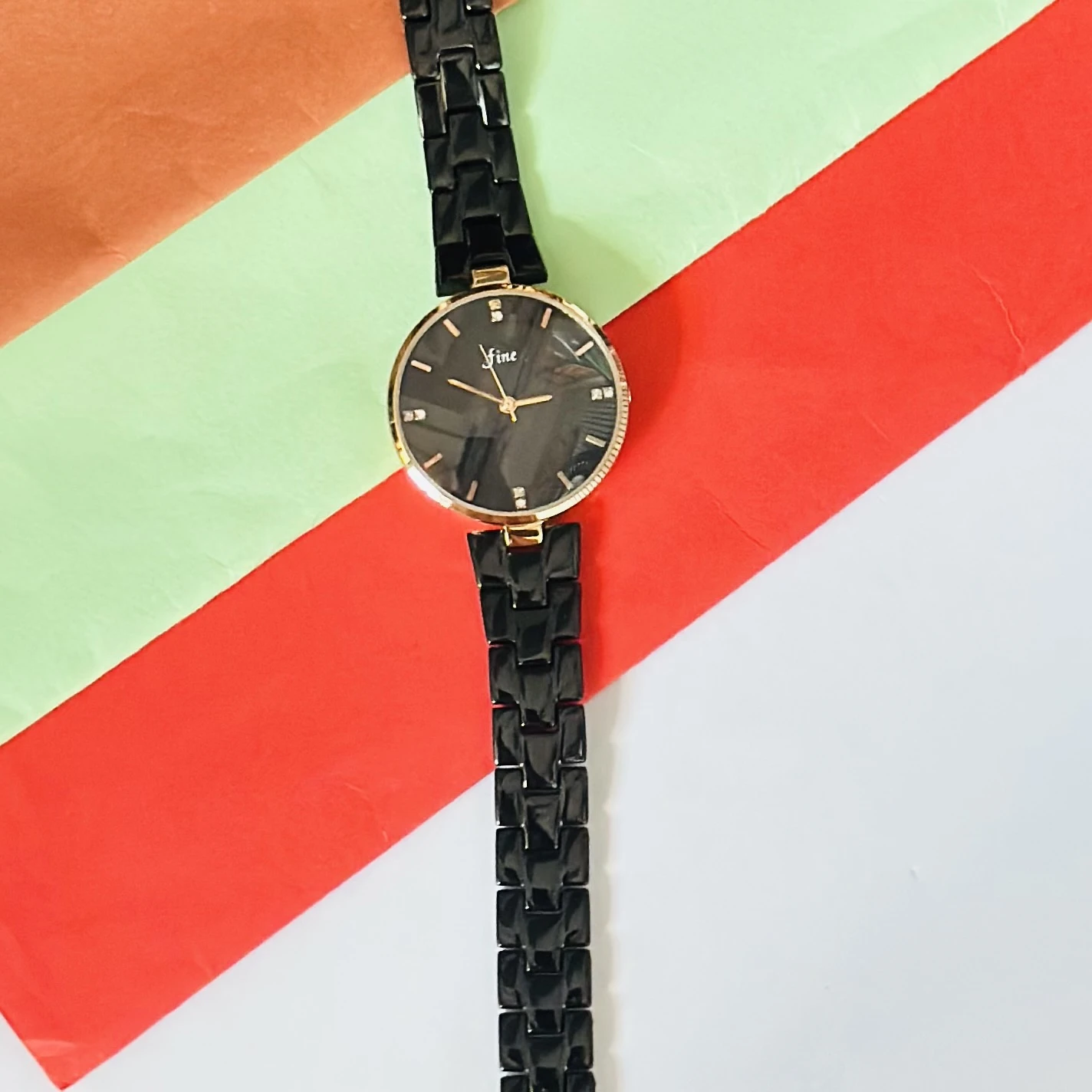 LeForce analog women's watch with a black dial, gold-plated case, and black bracelet strap
