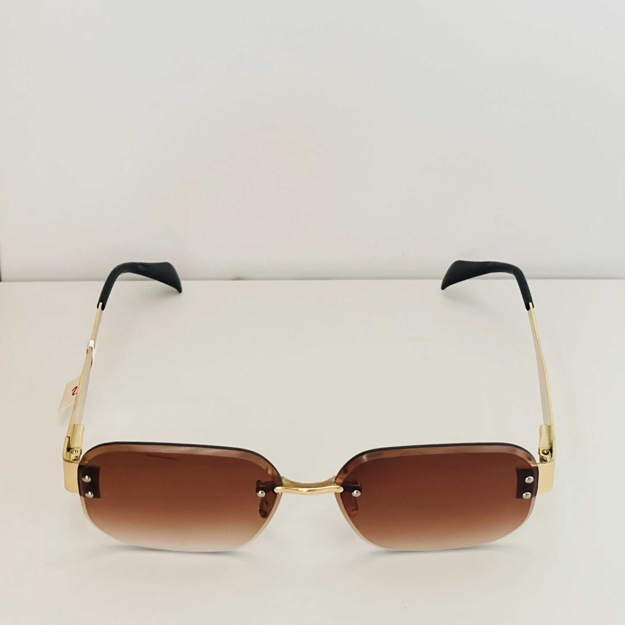 Rimless fashion sunglasses with brown gradient lenses and gold-toned hardware
