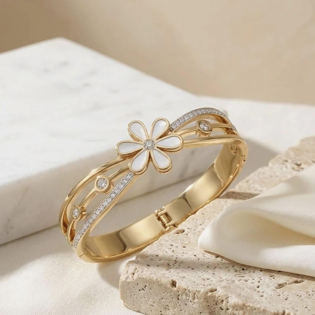 Gold tone hinged bangle bracelet
