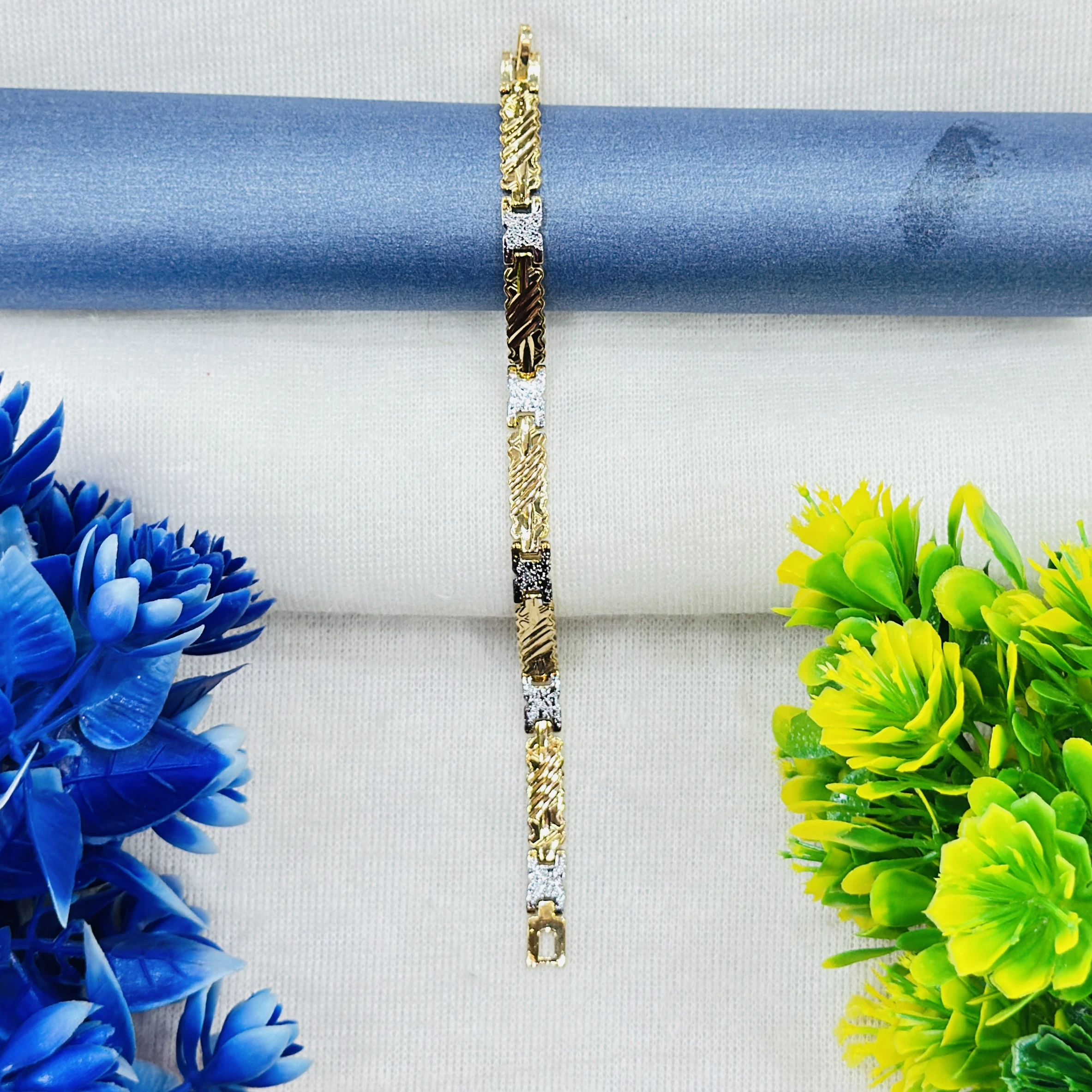 Gold plated men's bracelet featuring a textured, two-tone design.