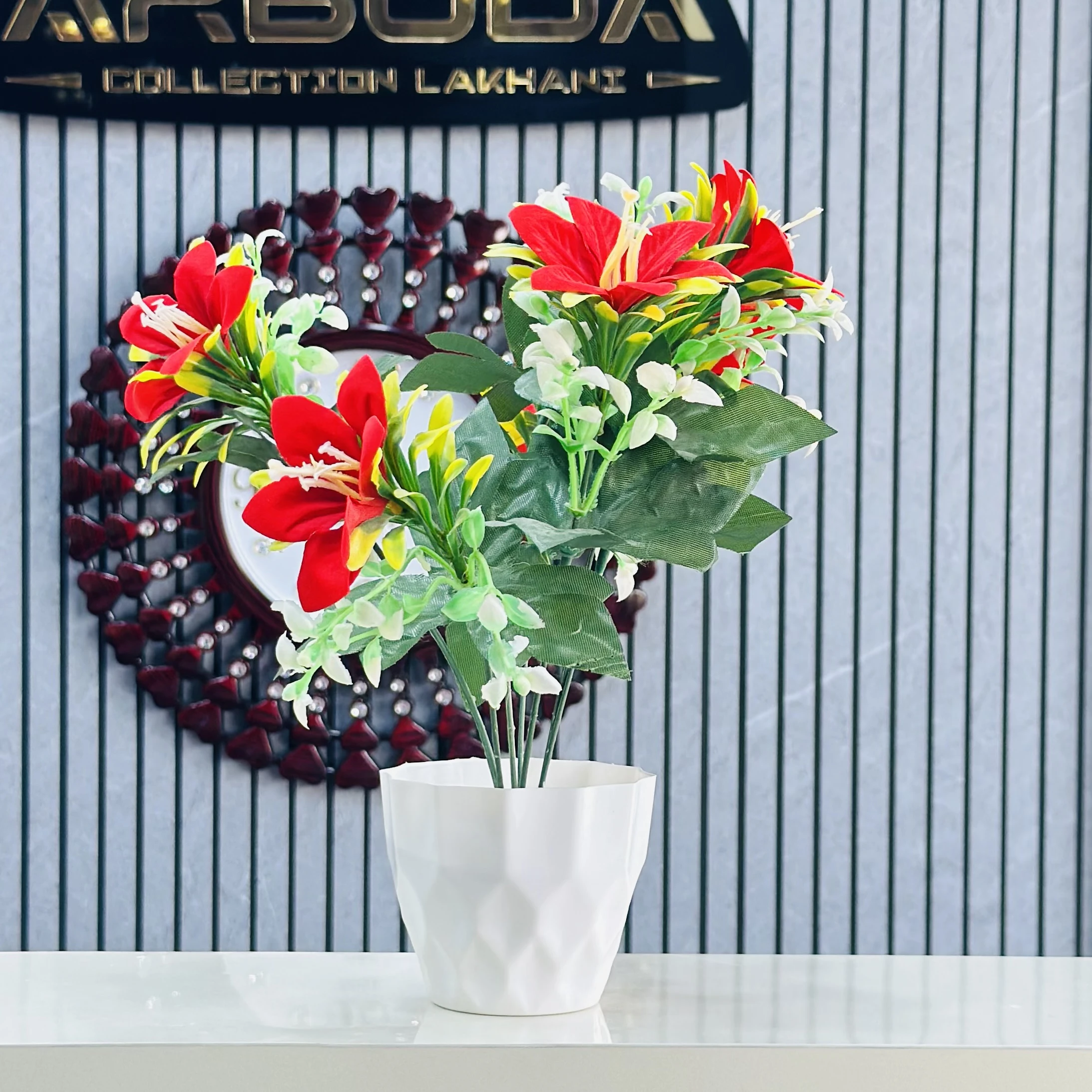 lily flower arrangement in a white pot.