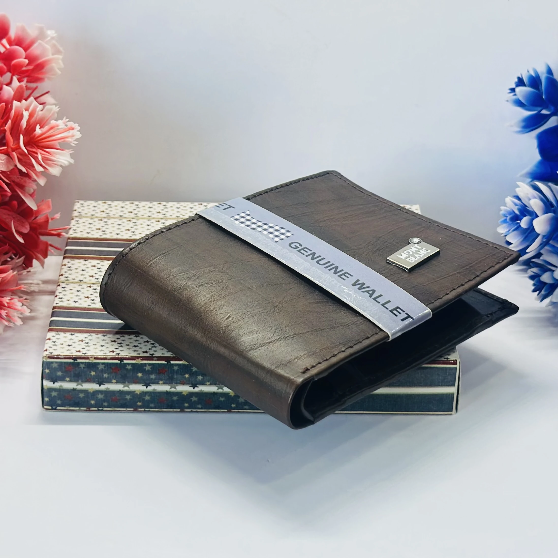 a brown bifold wallet, possibly made of genuine leather, branded as a Montblanc product.