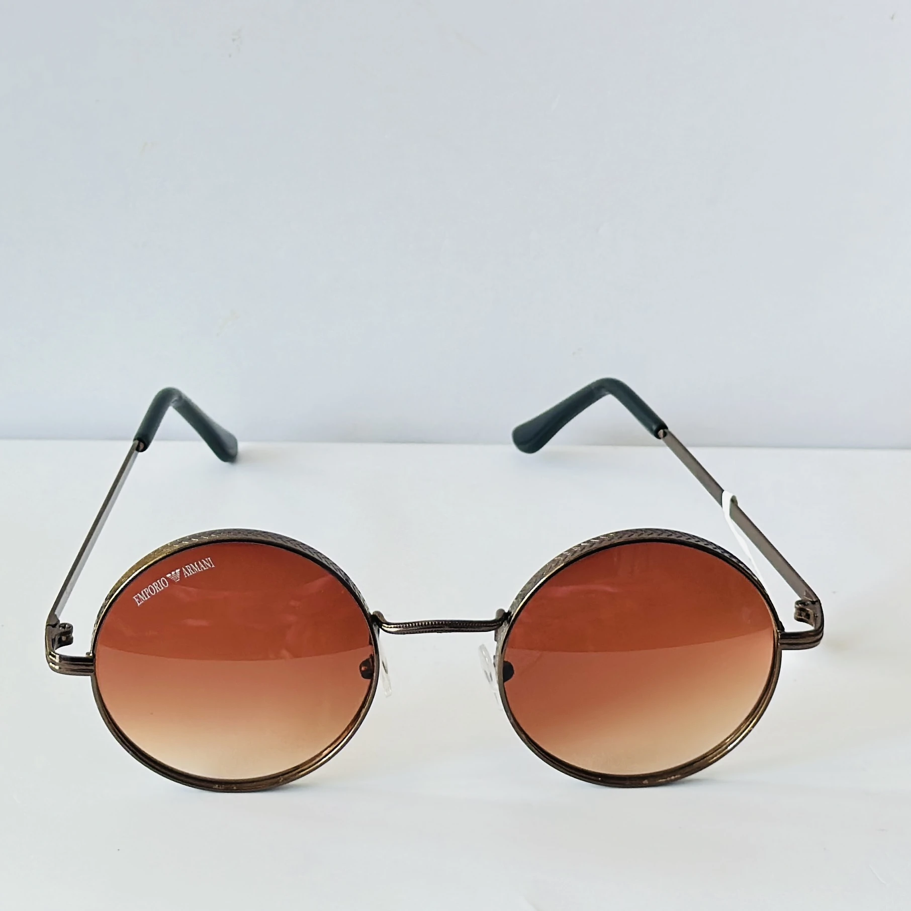 sunglasses are Emporio Armani round-frame