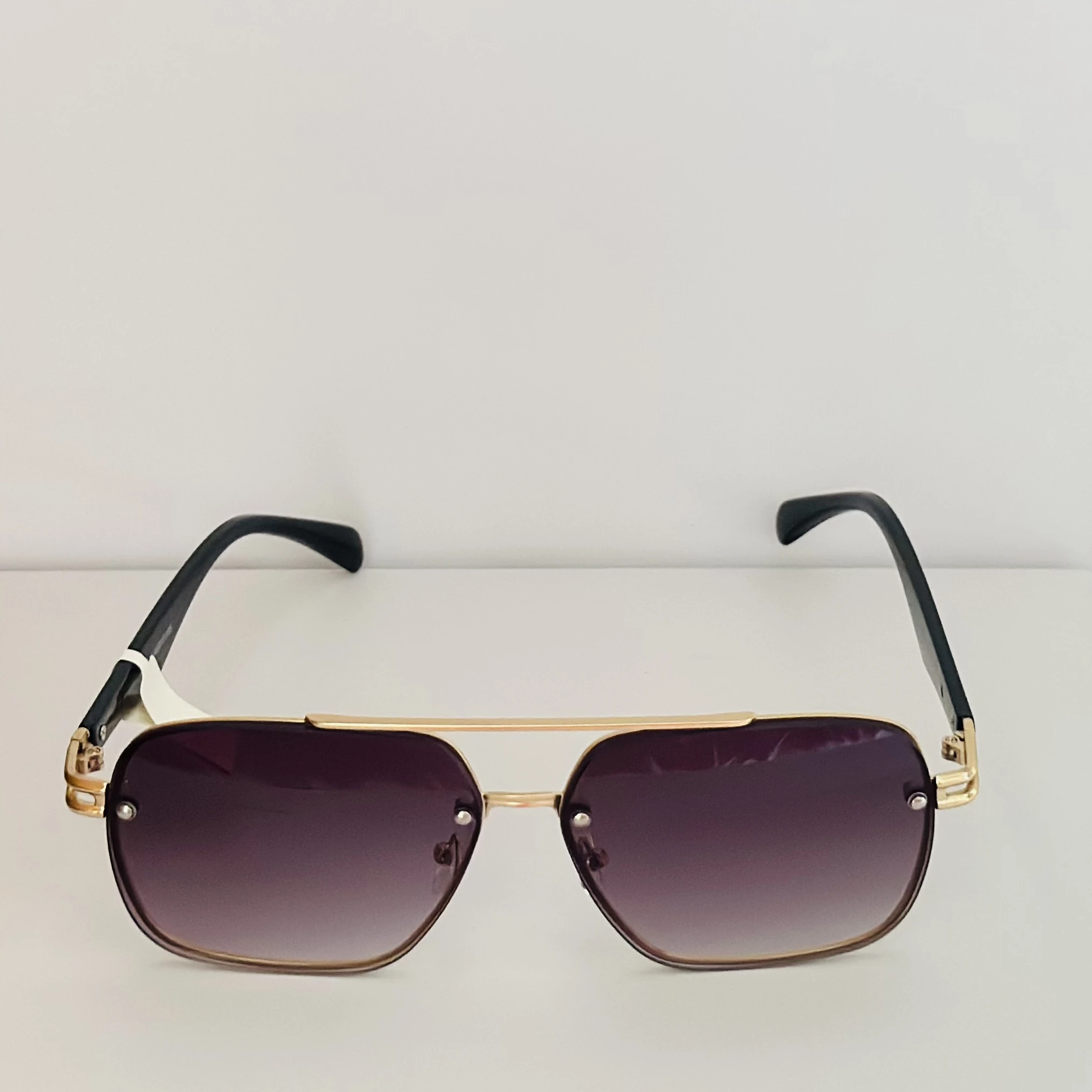 Thom Richard sunglasses with a gold metal frame and gradient lenses.