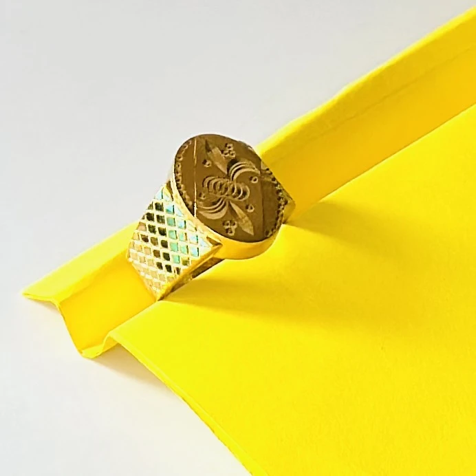 22kt yellow gold men's ring with a matte finish and machine-cut designs.