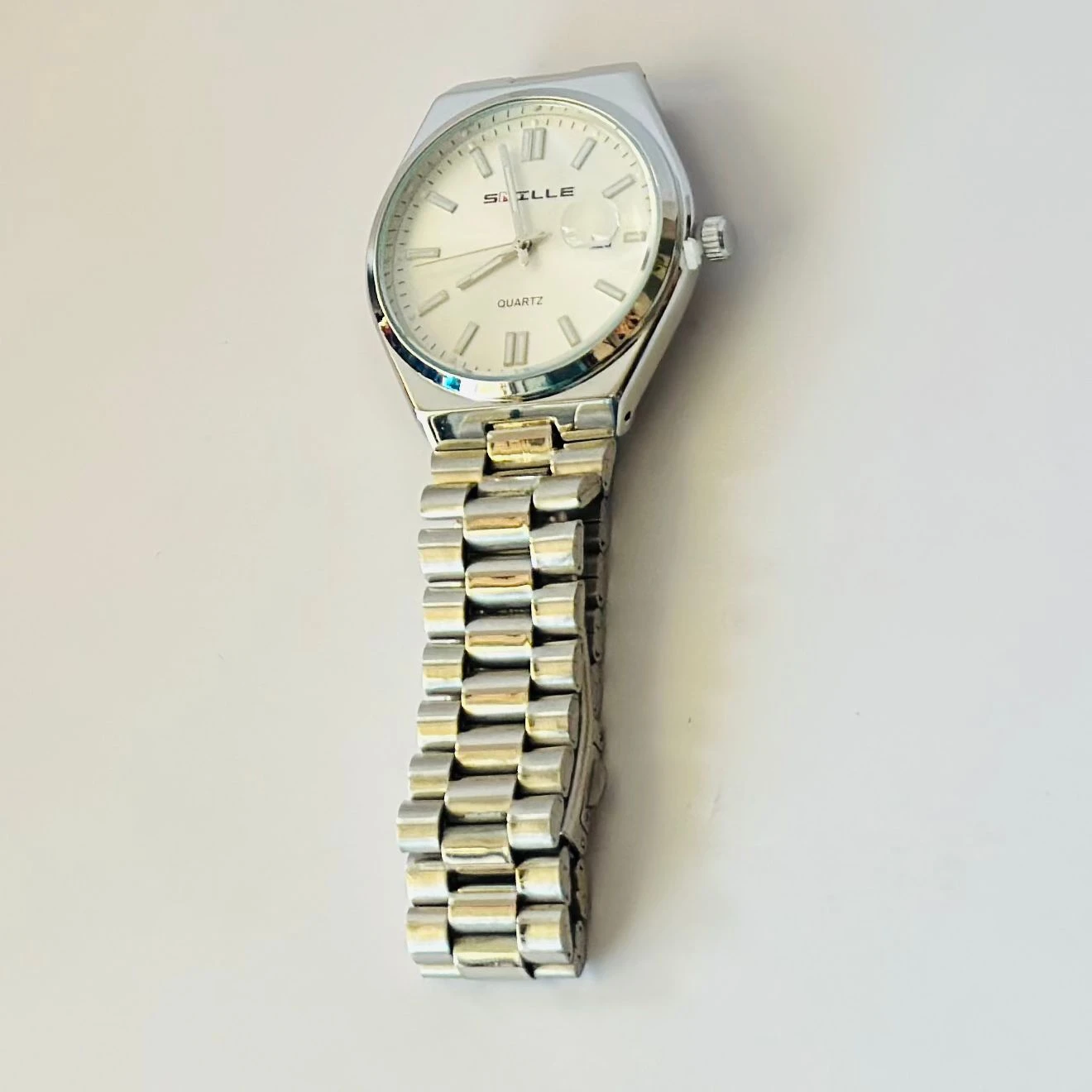 Snille analog quartz watch with a white dial and silver stainless steel strap.