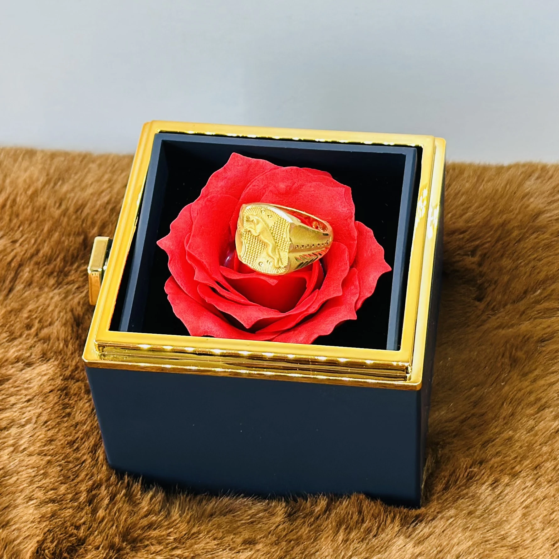 Gold toned men's ring with an embossed design
