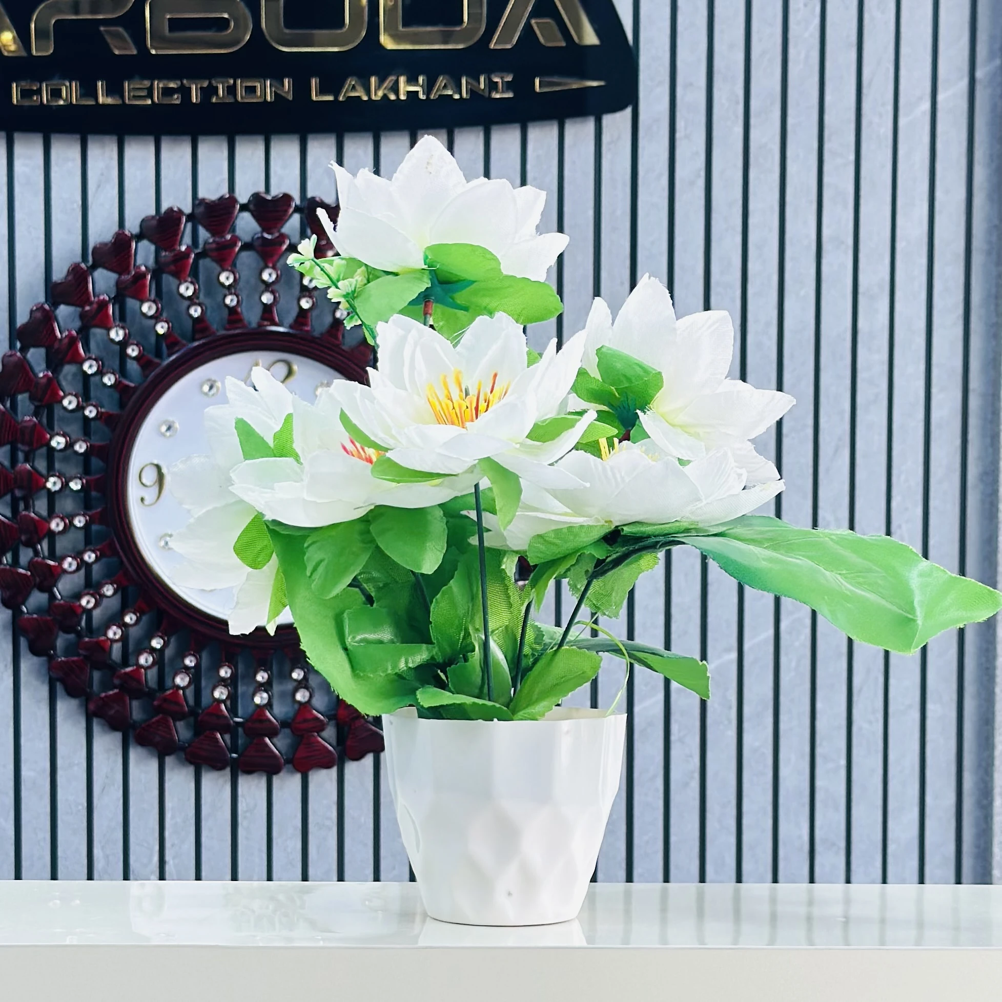 Flower arrangement in a white ceramic pot.