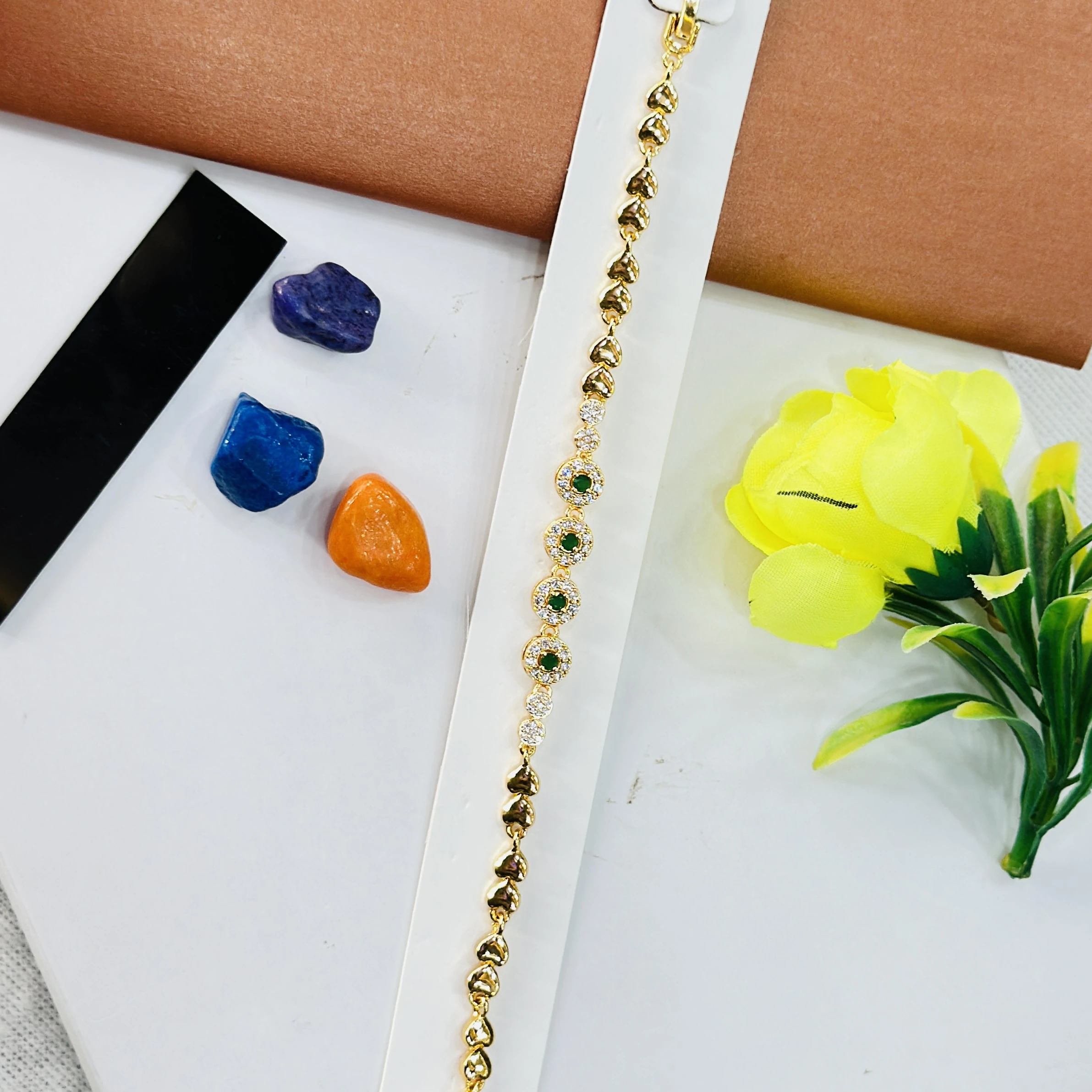Gold plated bracelet with green and white stones
