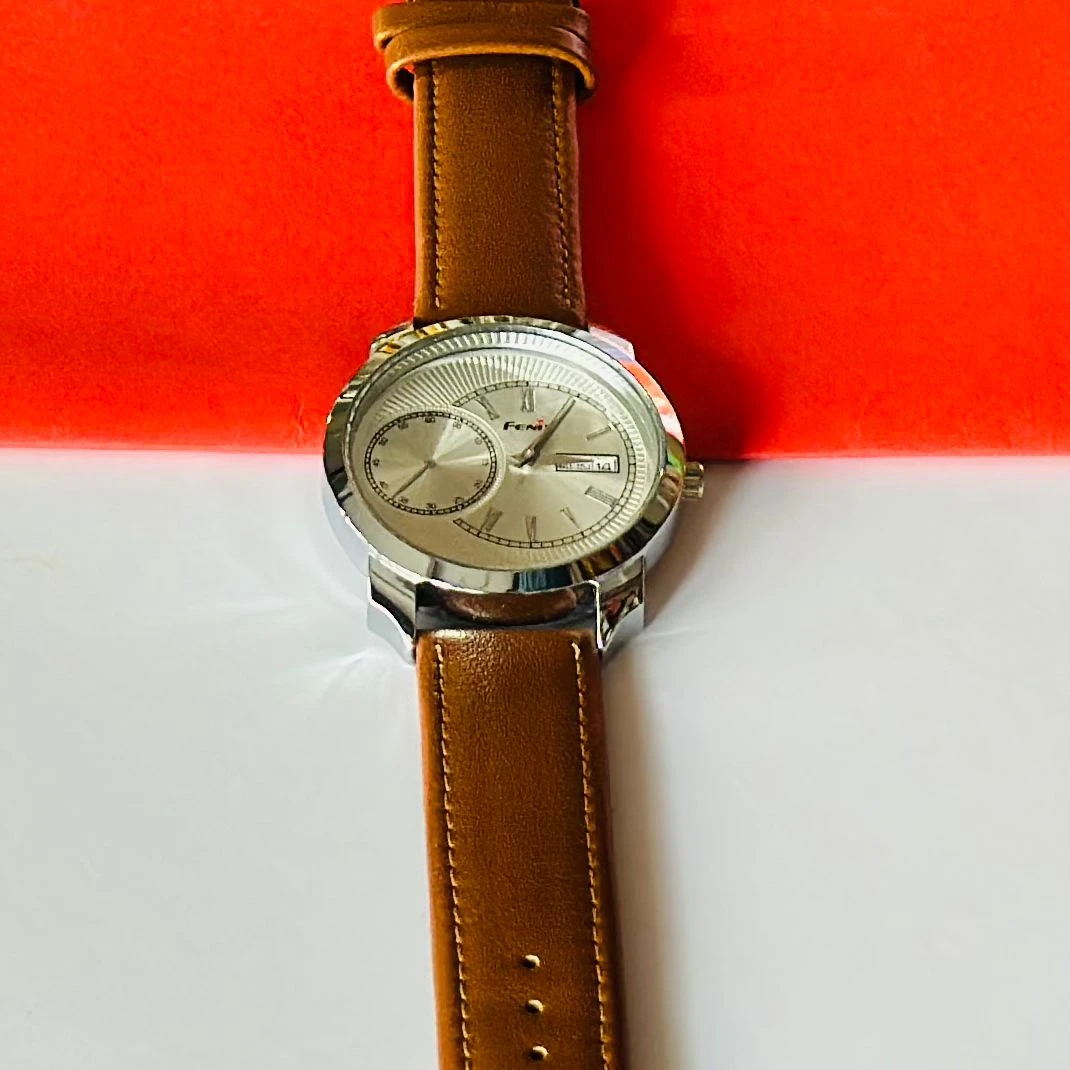 Round analog watch with a brown leather strap