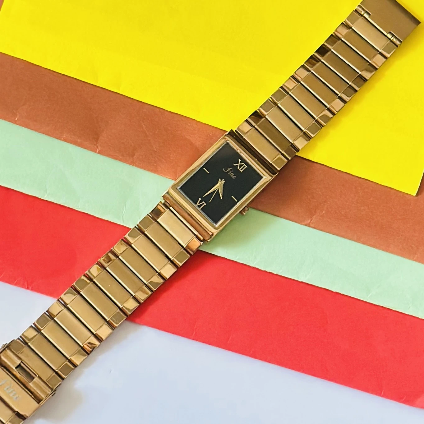 Gold -tone analog quartz watch with a metal strap.