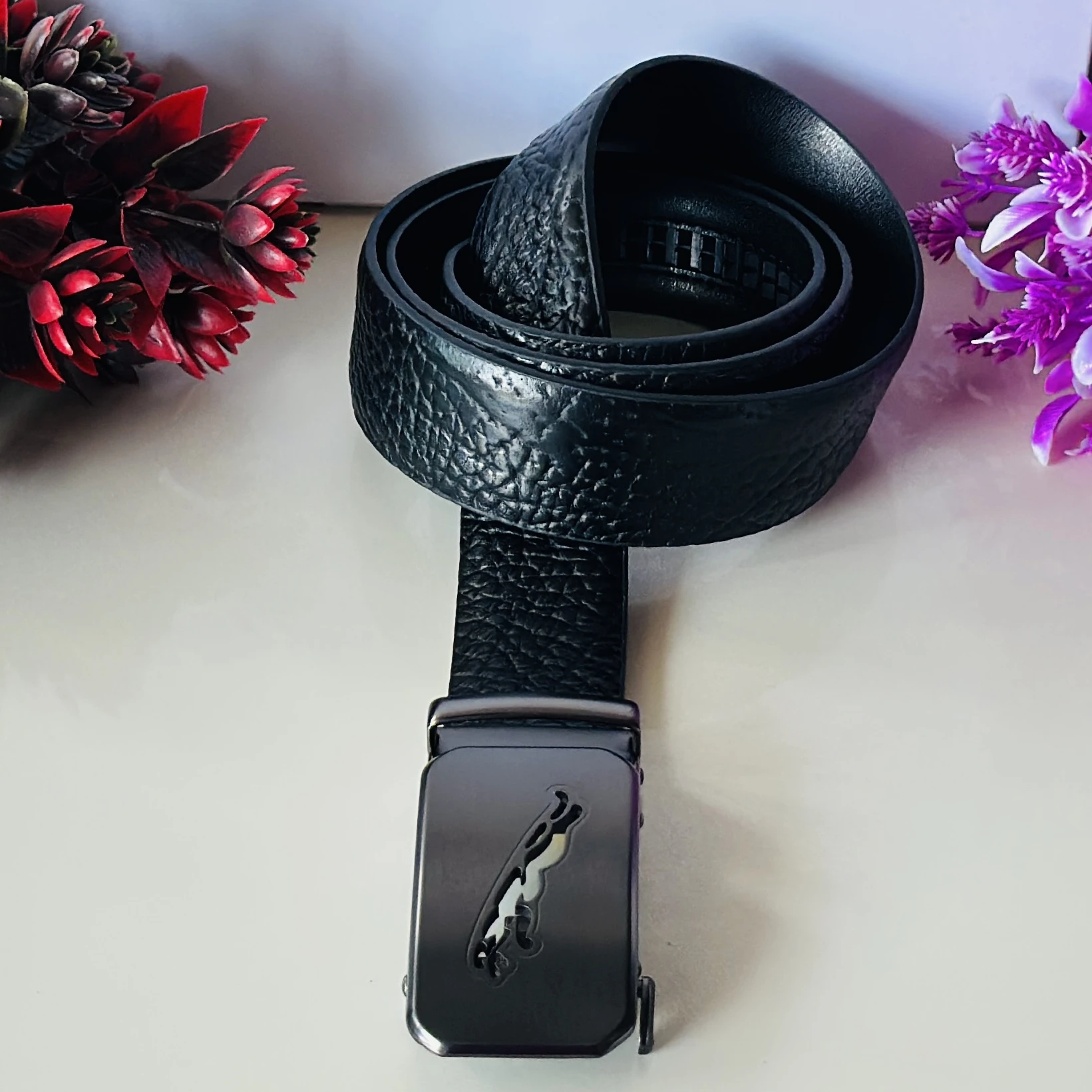 Black textured synthetic leather belt