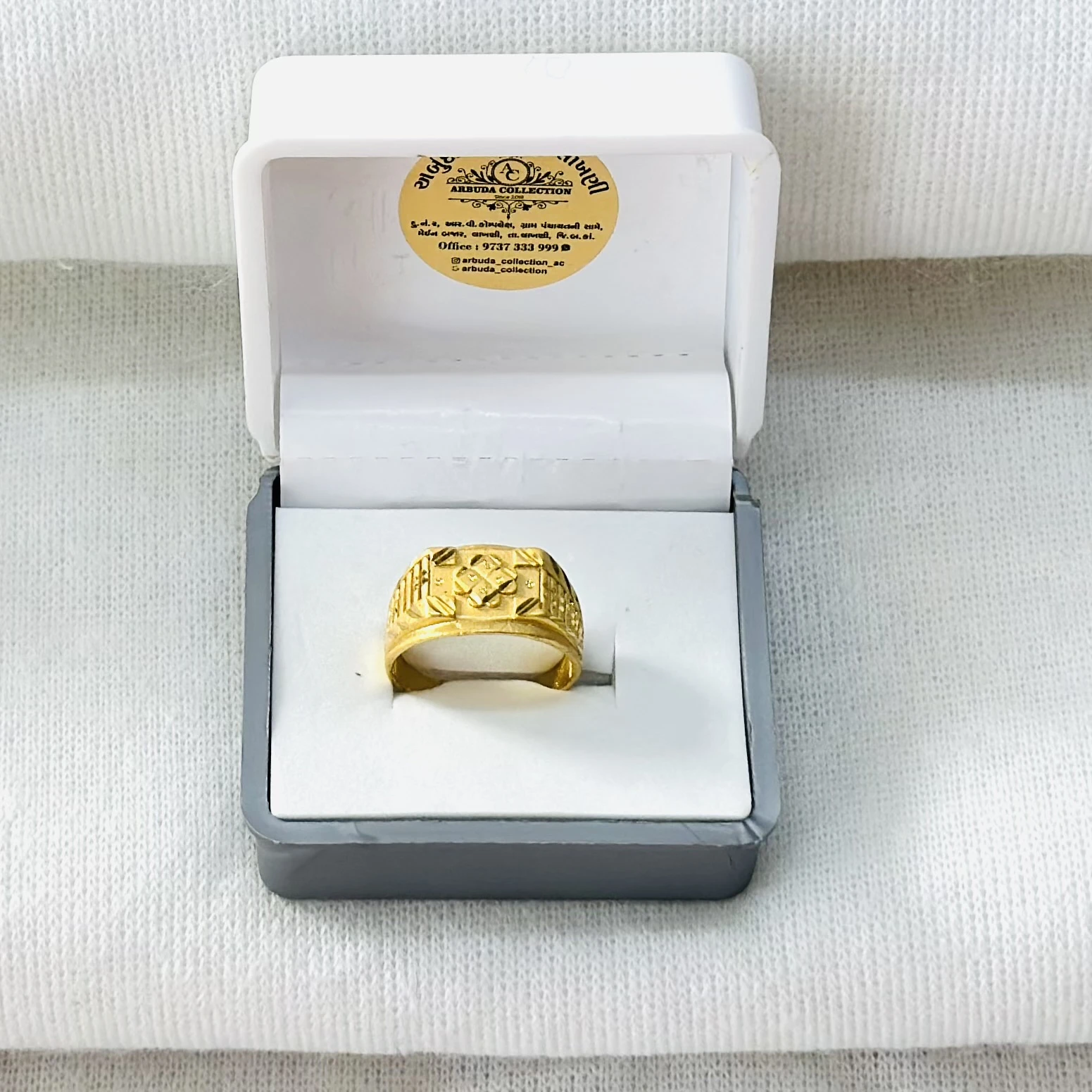 gold-toned men's ring with geometric patterns.