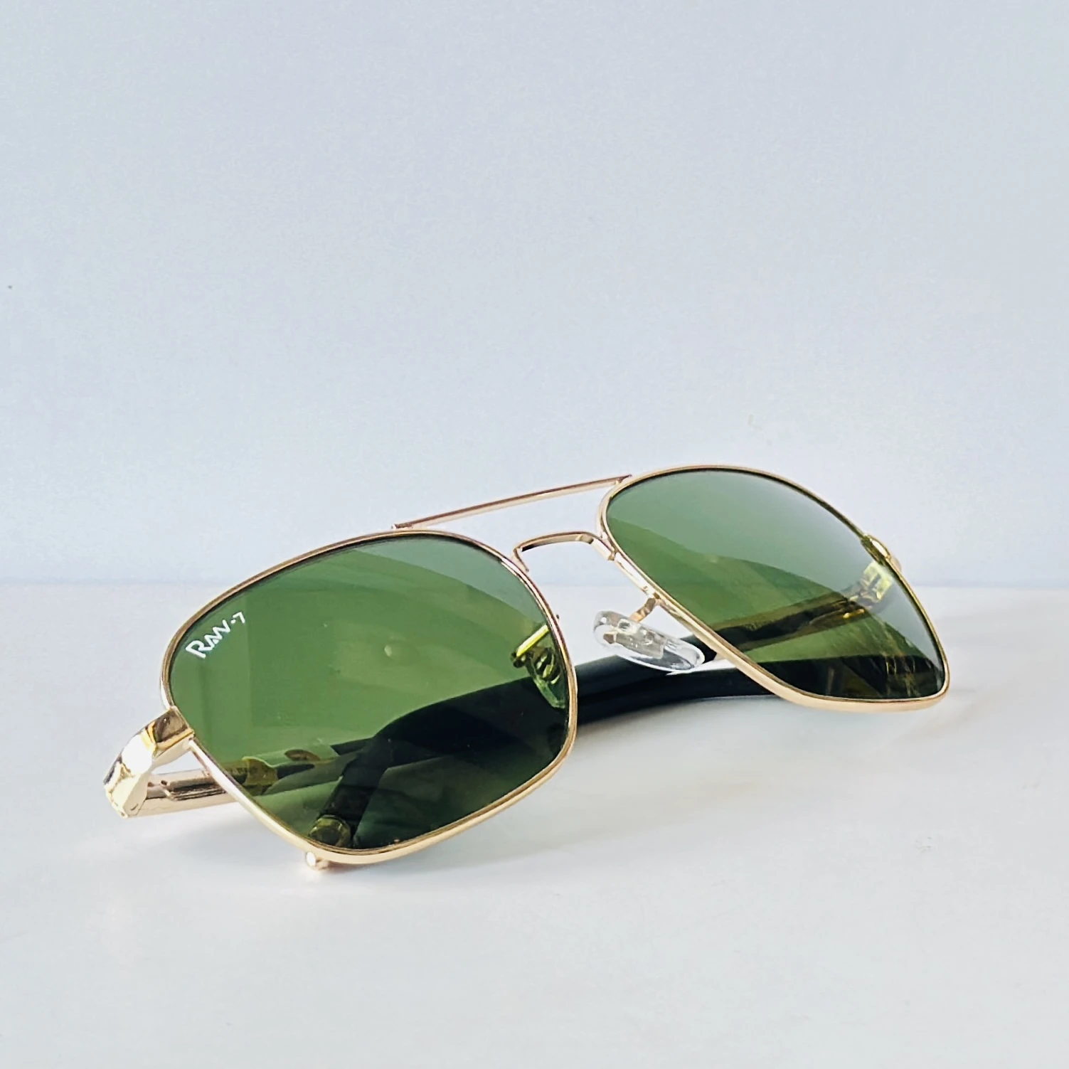 appear to be retro square or aviator-style sunglasses
