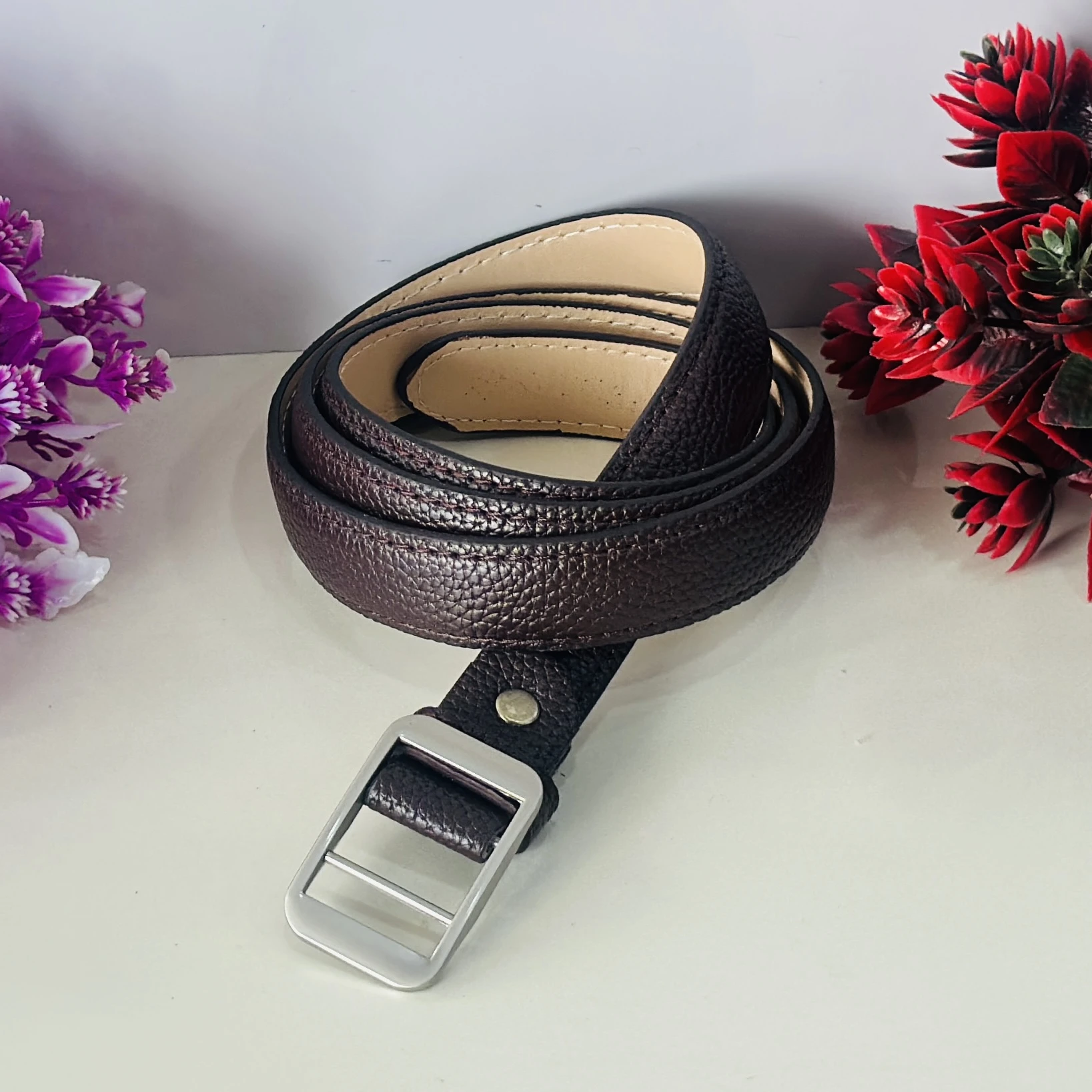 Brown leather belt with a silver-tone buckle.