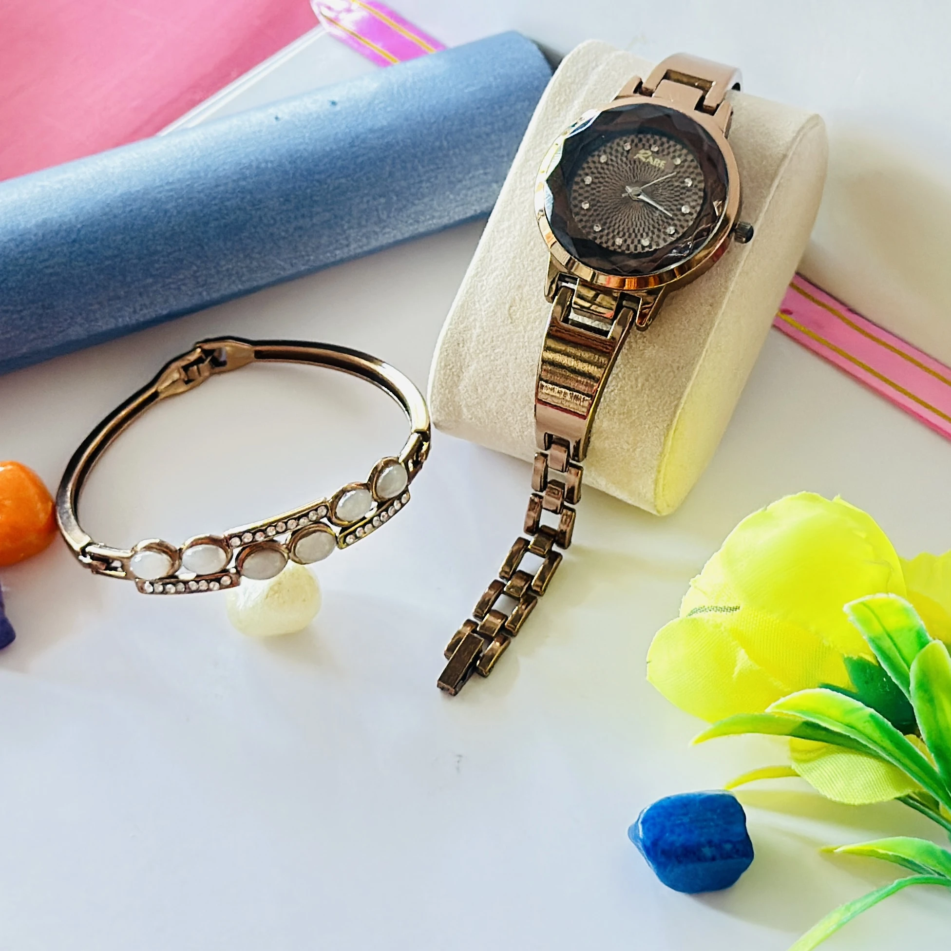 Rose gold-tone ladies wristwatch with a crystal-embellished round dial and bracelet strap.