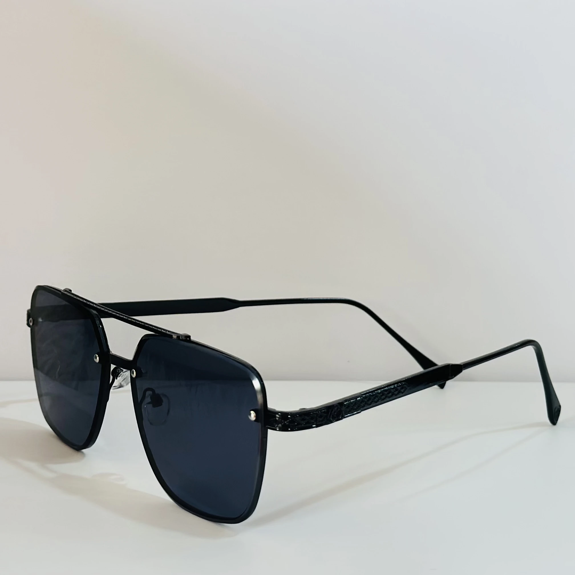 pair of MOONX Celebrity black UV protected sunglasses with a black frame.