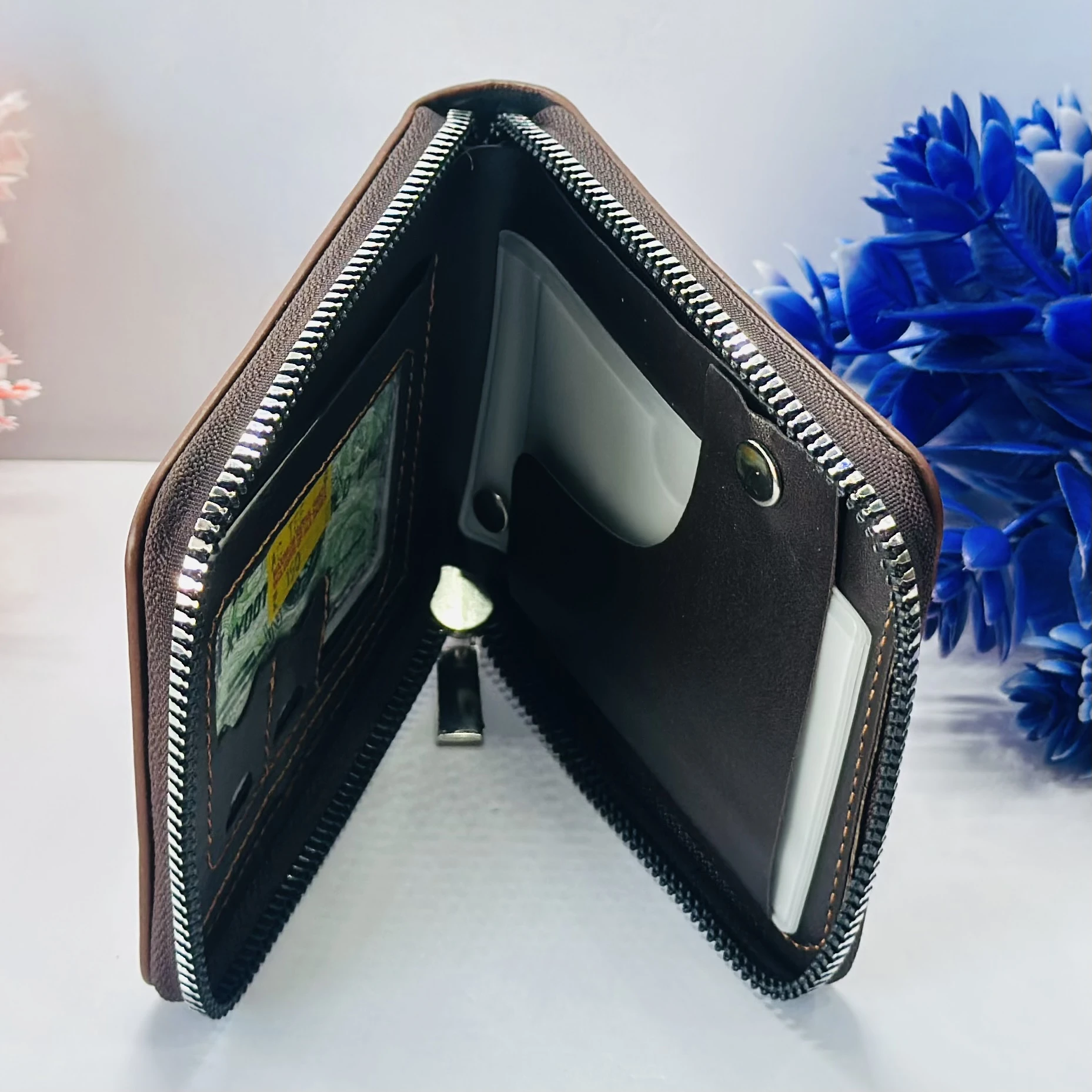 brown leather zip-around wallet with a "bovis" logo.
