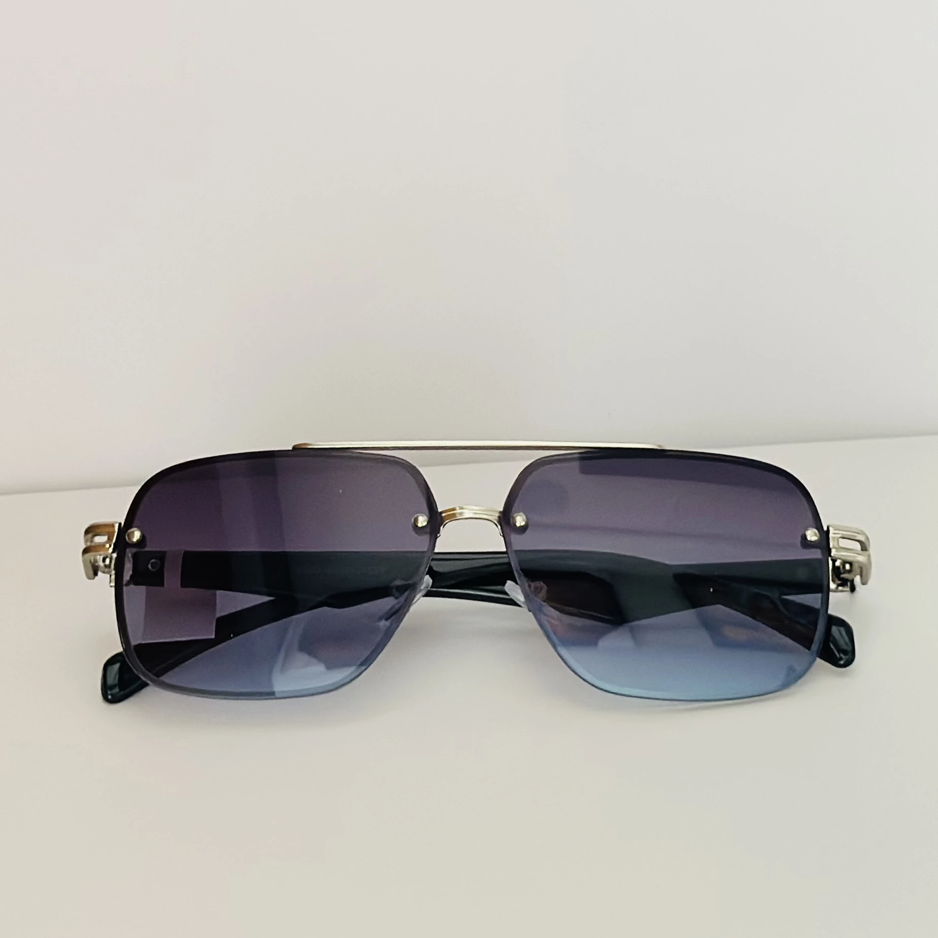 GOGLASSIC GG2317 rectangle sunglasses featuring a silver-tone metal frame and blue gradient UV-protected lenses.