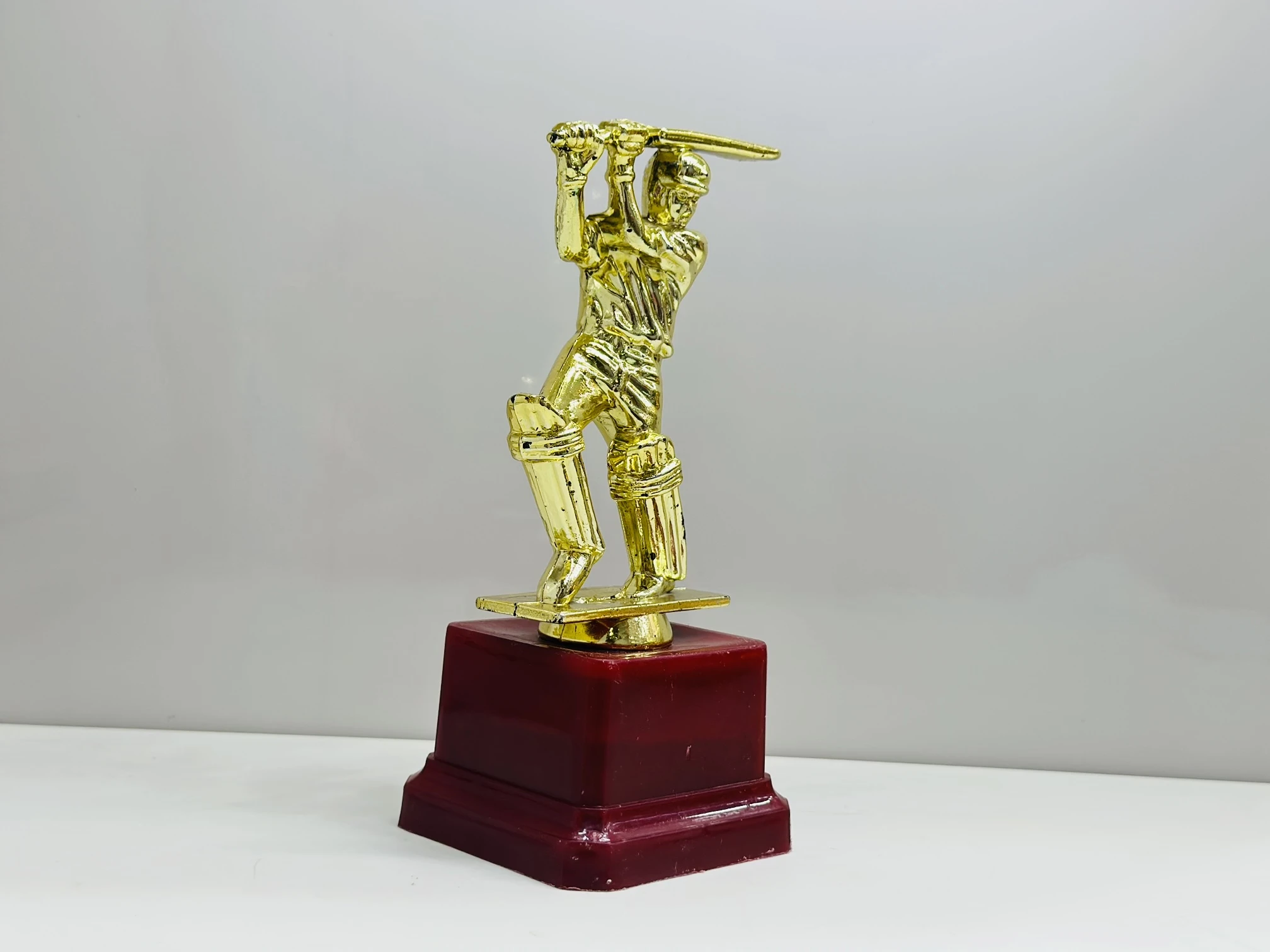 cricket trophy featuring a batsman figure.