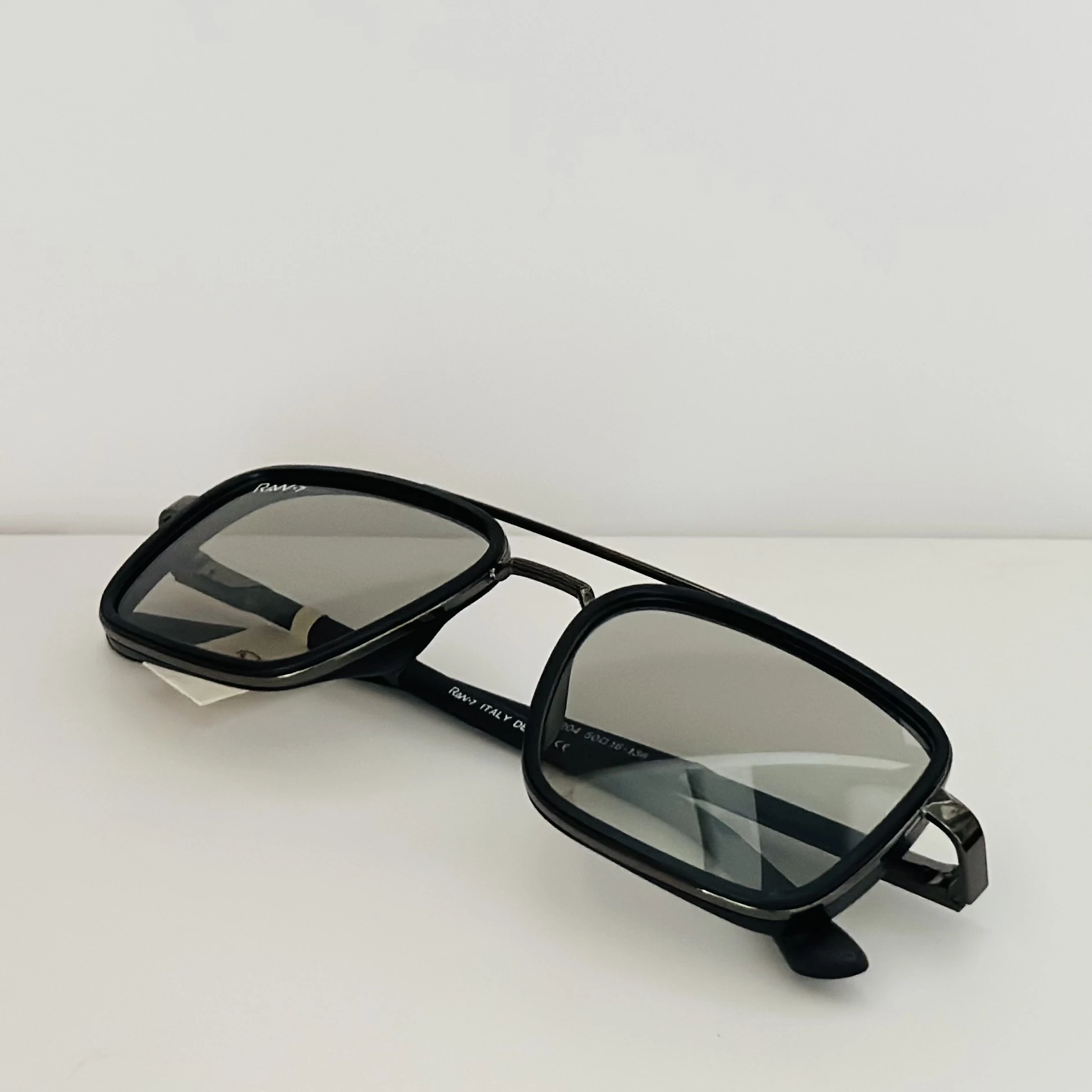 RAW-7 aviator sunglasses with a black frame and silver lenses.