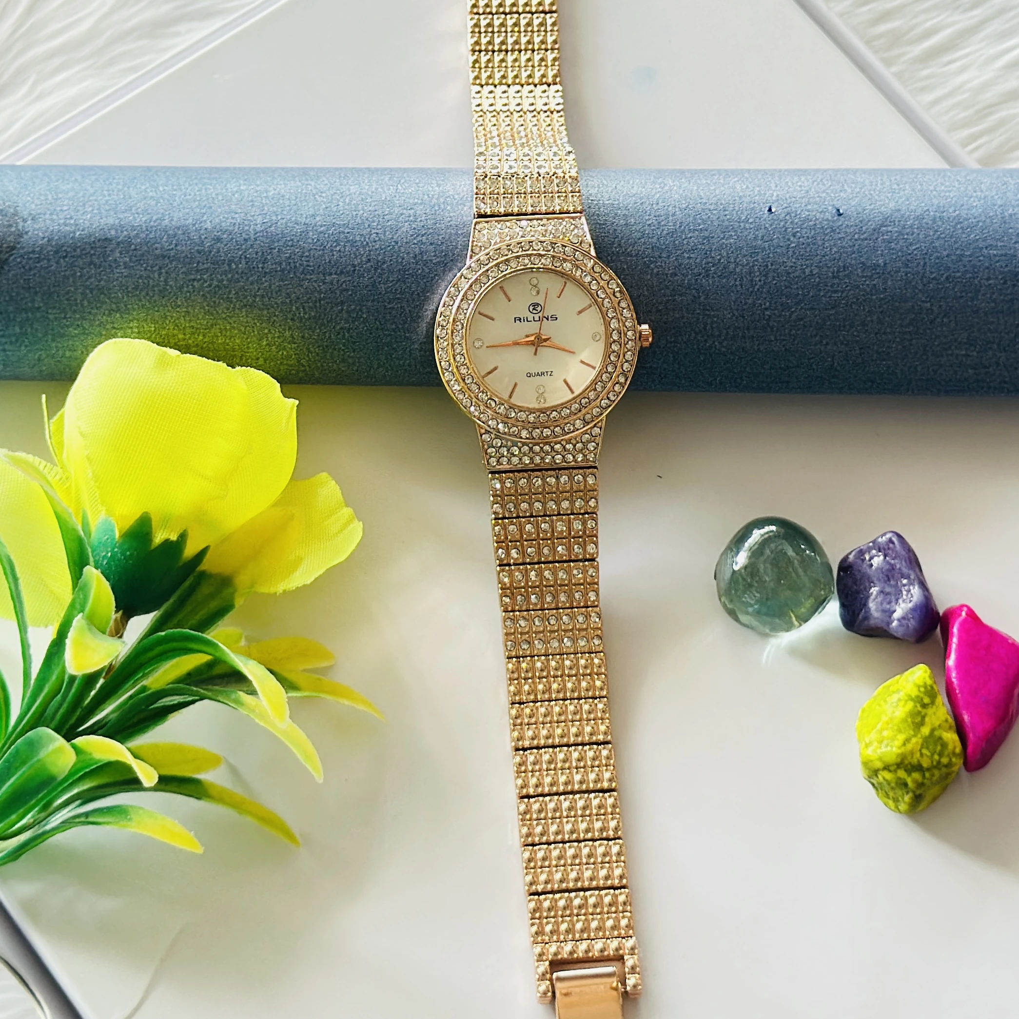 Gold toned Riluns analog quartz watch embellished with rhinestones