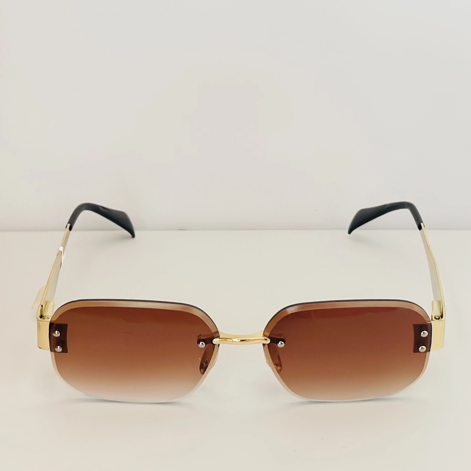 Rimless fashion sunglasses with brown gradient lenses and gold-toned hardware