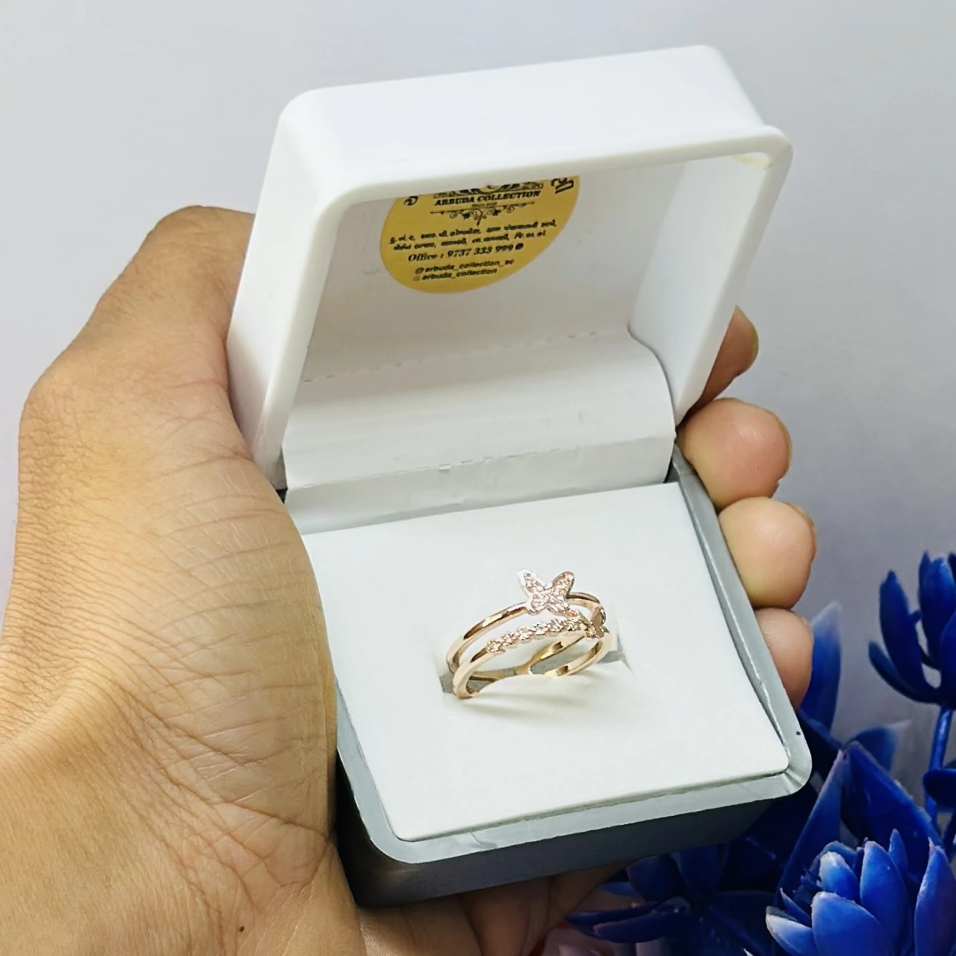 Rose gold plated cubic zirconia butterfly double band ring.