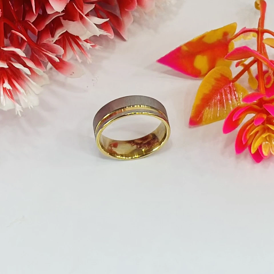 gold and silver-toned stainless steel dual-edge wedding band with a brushed finish