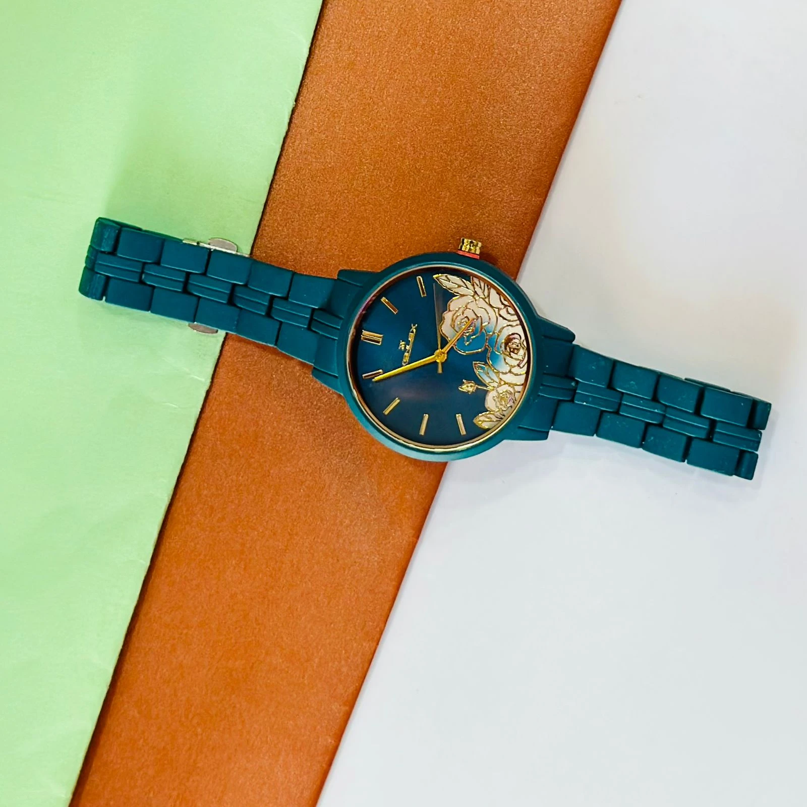 TEAL BY CHUMBAK Tulip Garden Quilted Analog Watch for Women in a teal blue hue.