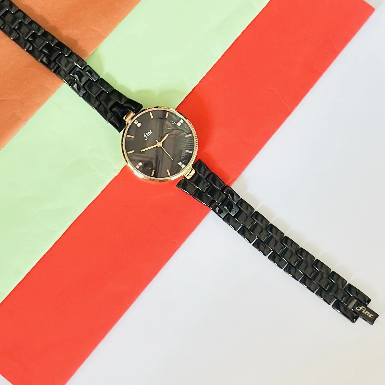 LeForce analog women's watch with a black dial, gold-plated case, and black bracelet strap