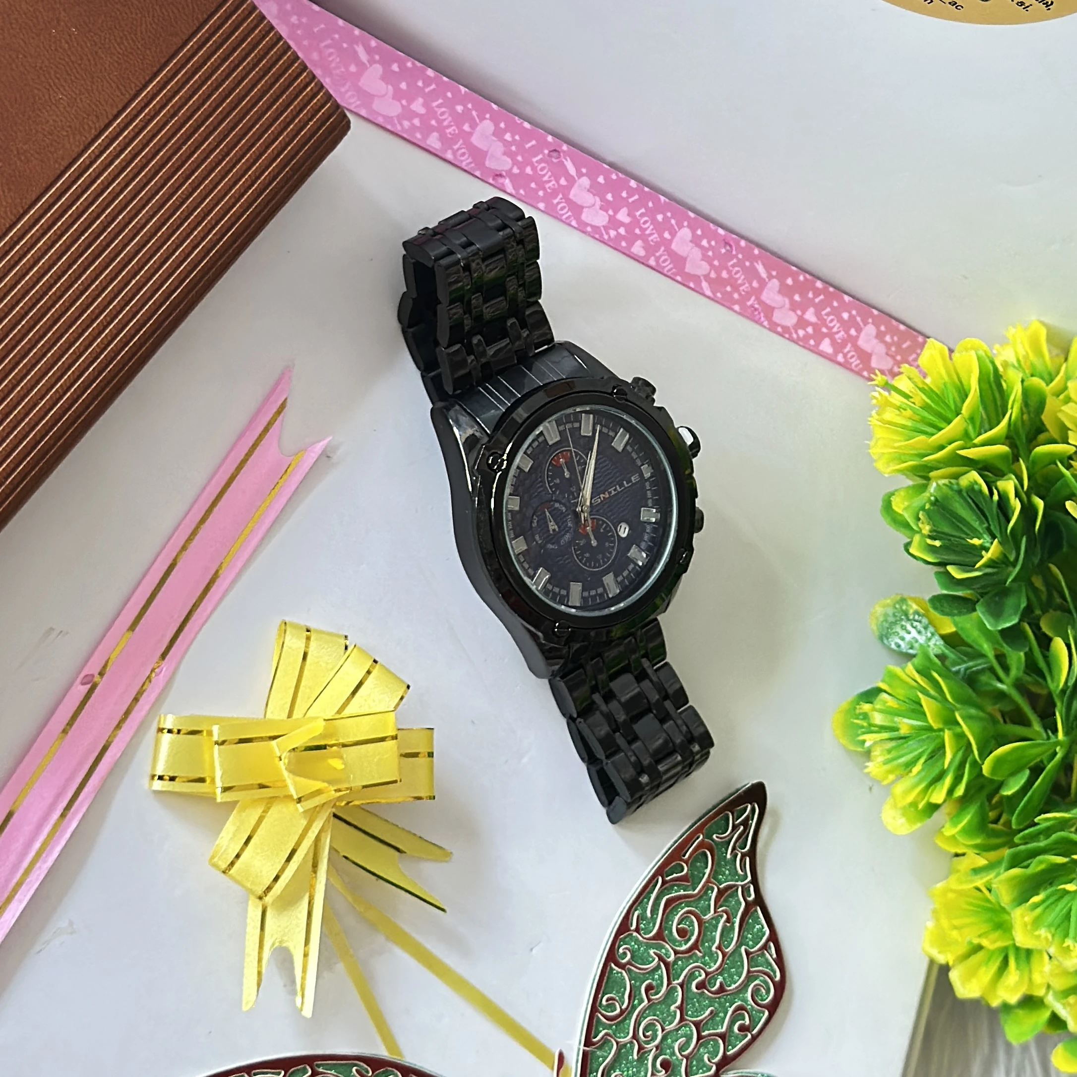 Snille brand wristwatch features a black analog