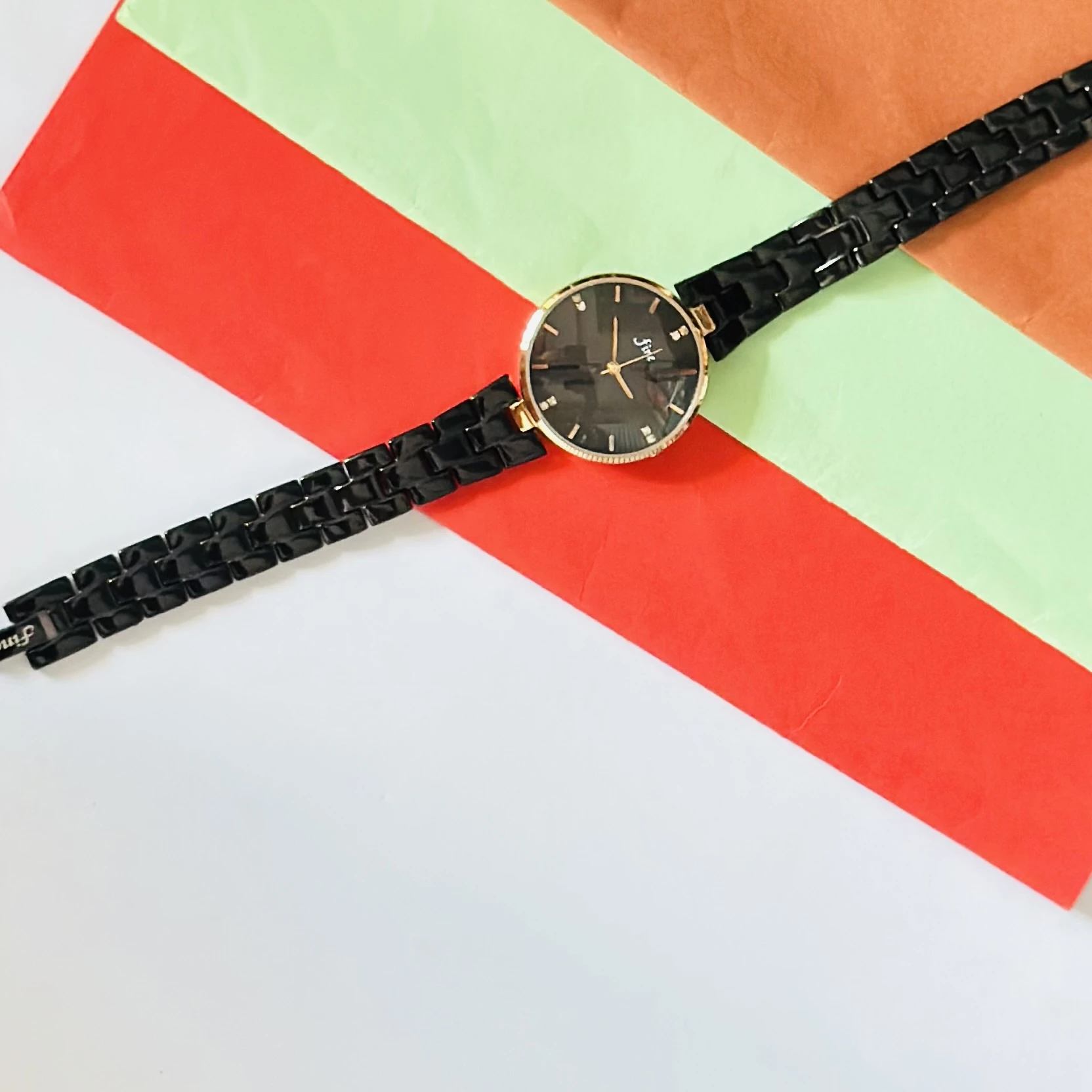 LeForce analog women's watch with a black dial, gold-plated case, and black bracelet strap