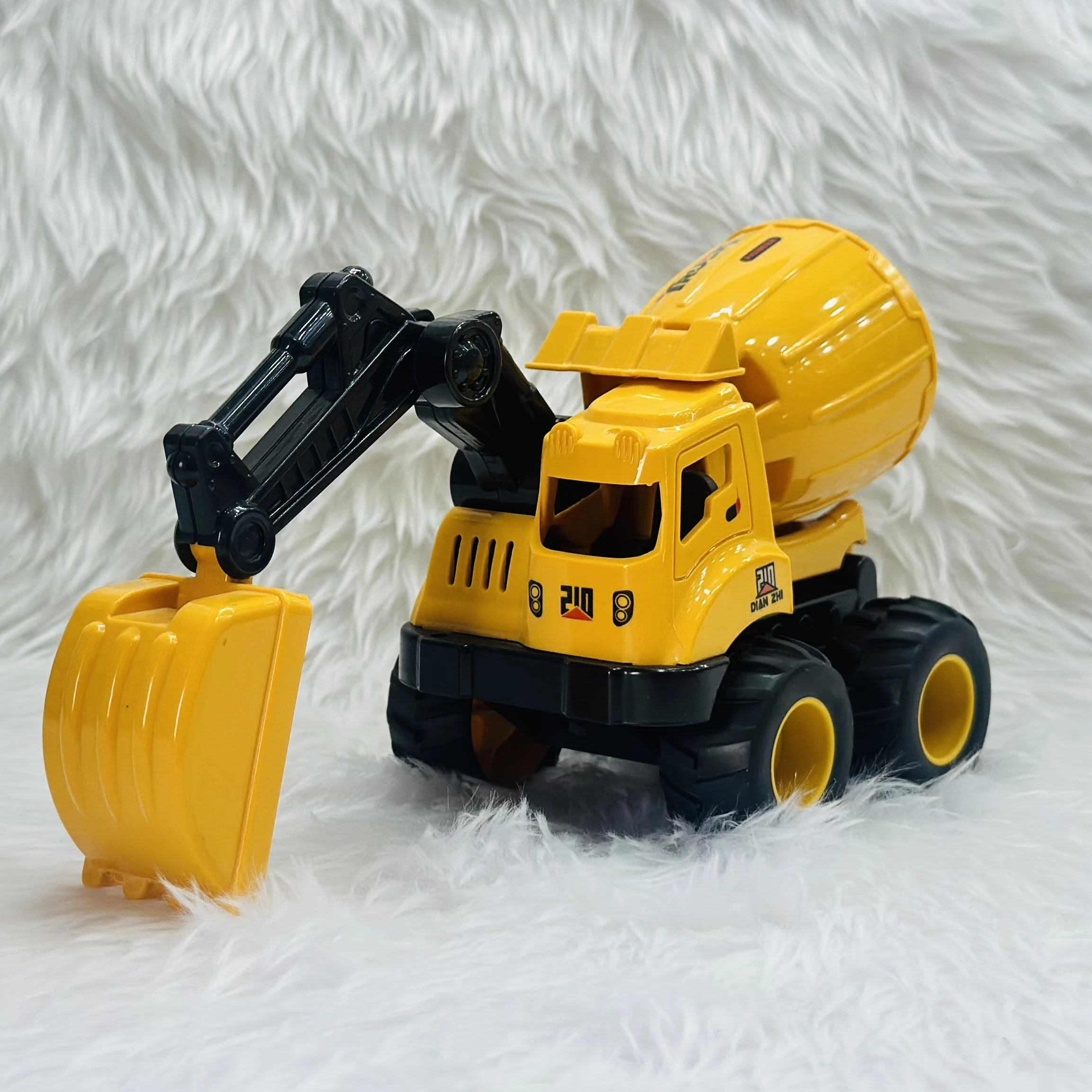 Cement mixer with an attached excavator arm.