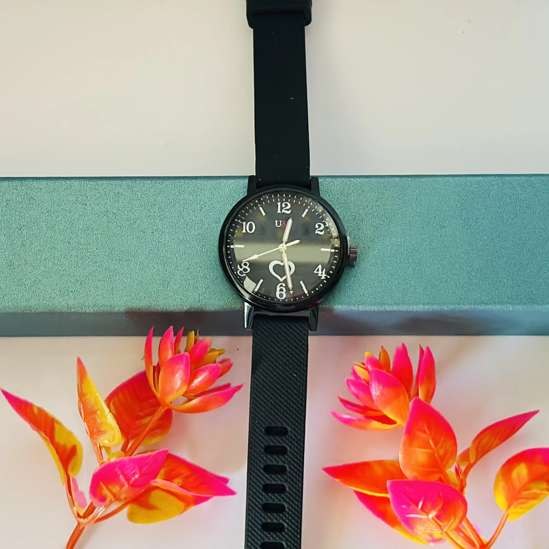 women's black silicone strap watch with an easy-to-read dial.
